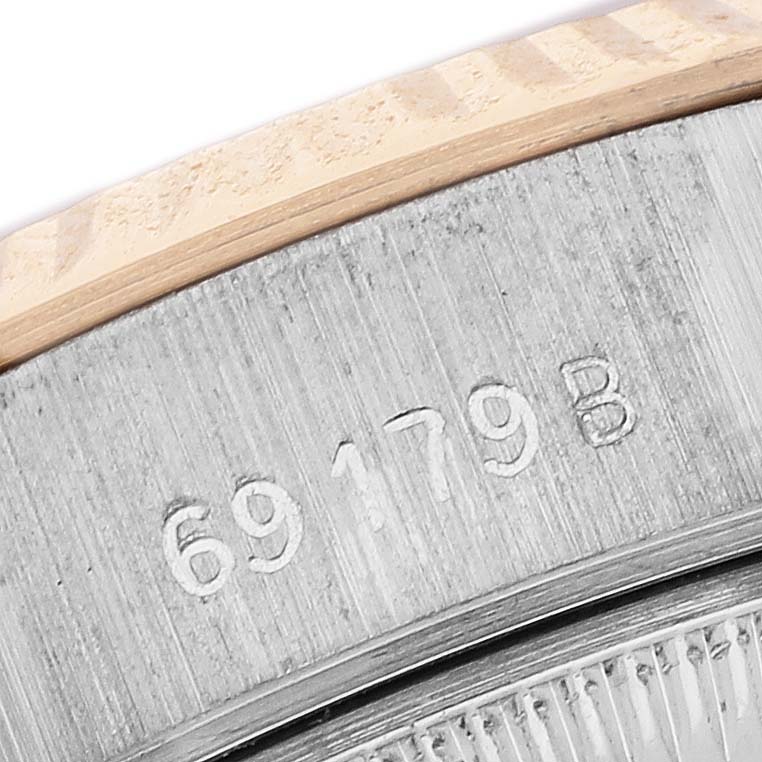 This close-up image shows the edge of the caseback with model number "69179 B" engraved on a Rolex President 69179 Women's White Gold Brown Dial watch.