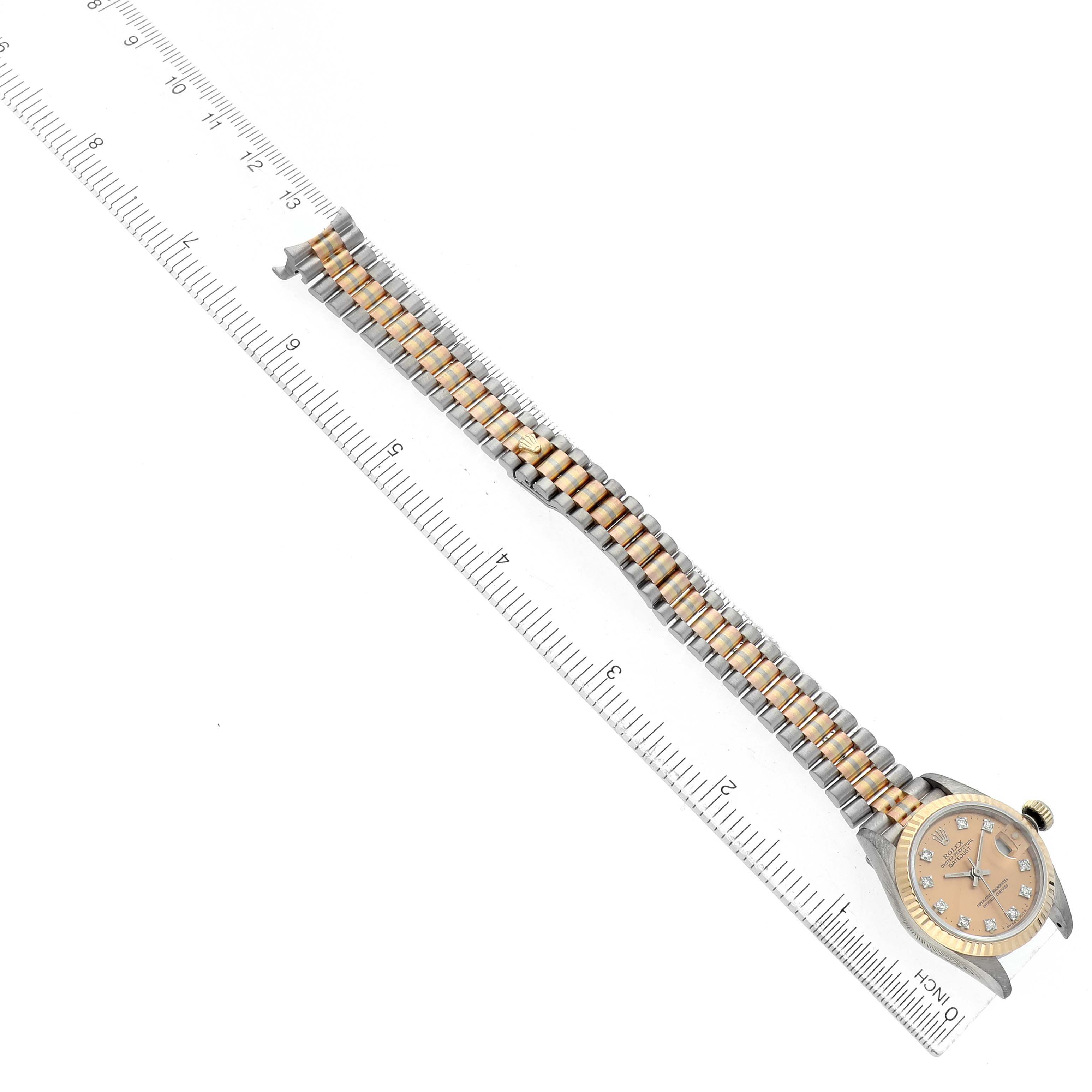 The image shows a Rolex President 69179 Women's White Gold Brown Dial watch from an overhead angle, displaying the dial, bracelet, and bezel alongside a ruler for scale.