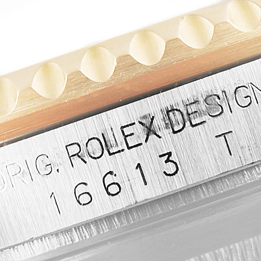 The image shows a close-up of the model number and part of the bezel of a Rolex Submariner 16613 Men's Steel and Gold (two tone) Blue Dial 16613 Men's Steel and Gold (two tone) Blue Dial watch.