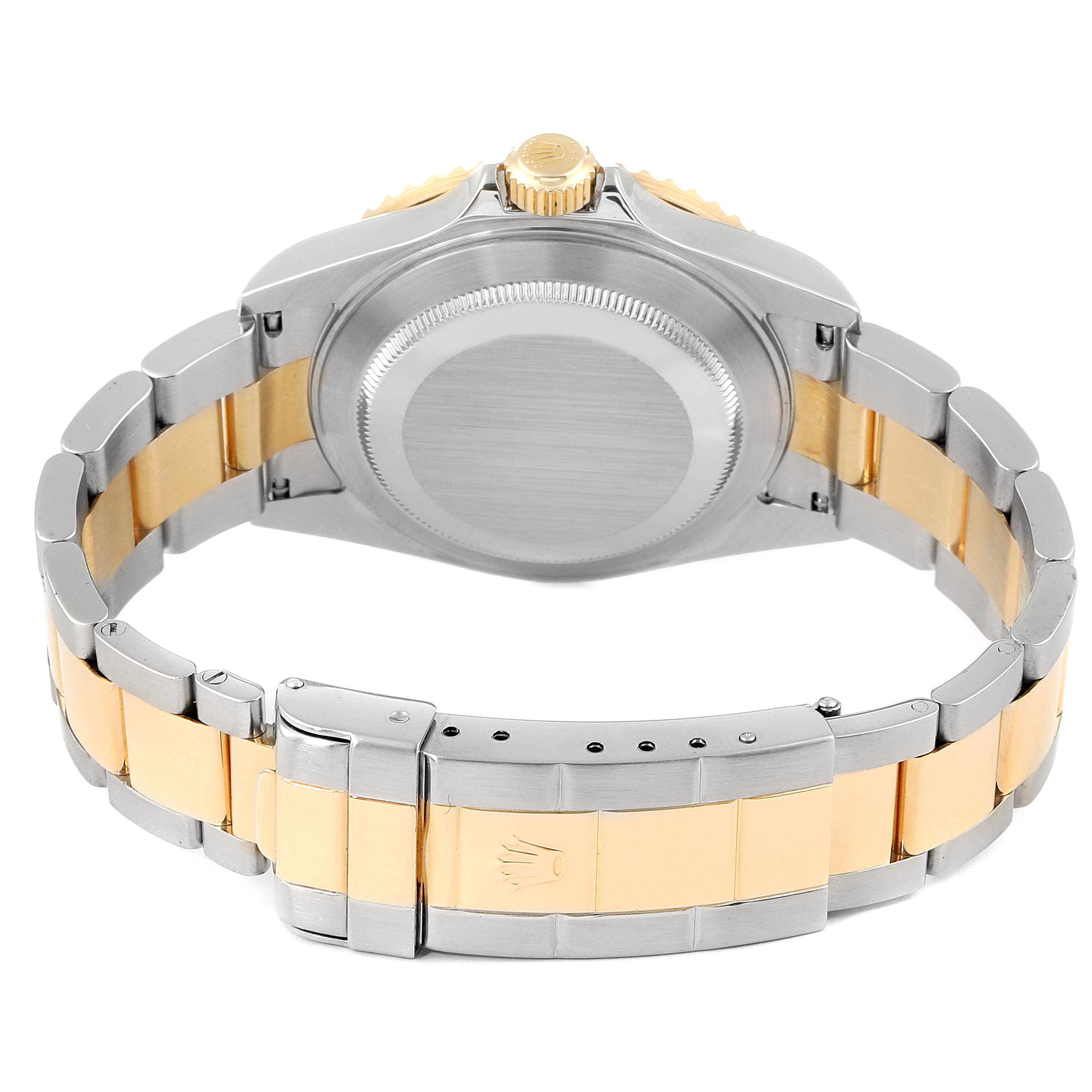 The image shows the back side of a Rolex Submariner 16613 Men's Steel and Gold (two tone) Blue Dial 16613 Men's Steel and Gold (two tone) Blue Dial watch, highlighting the clasp and bracelet in steel and gold.