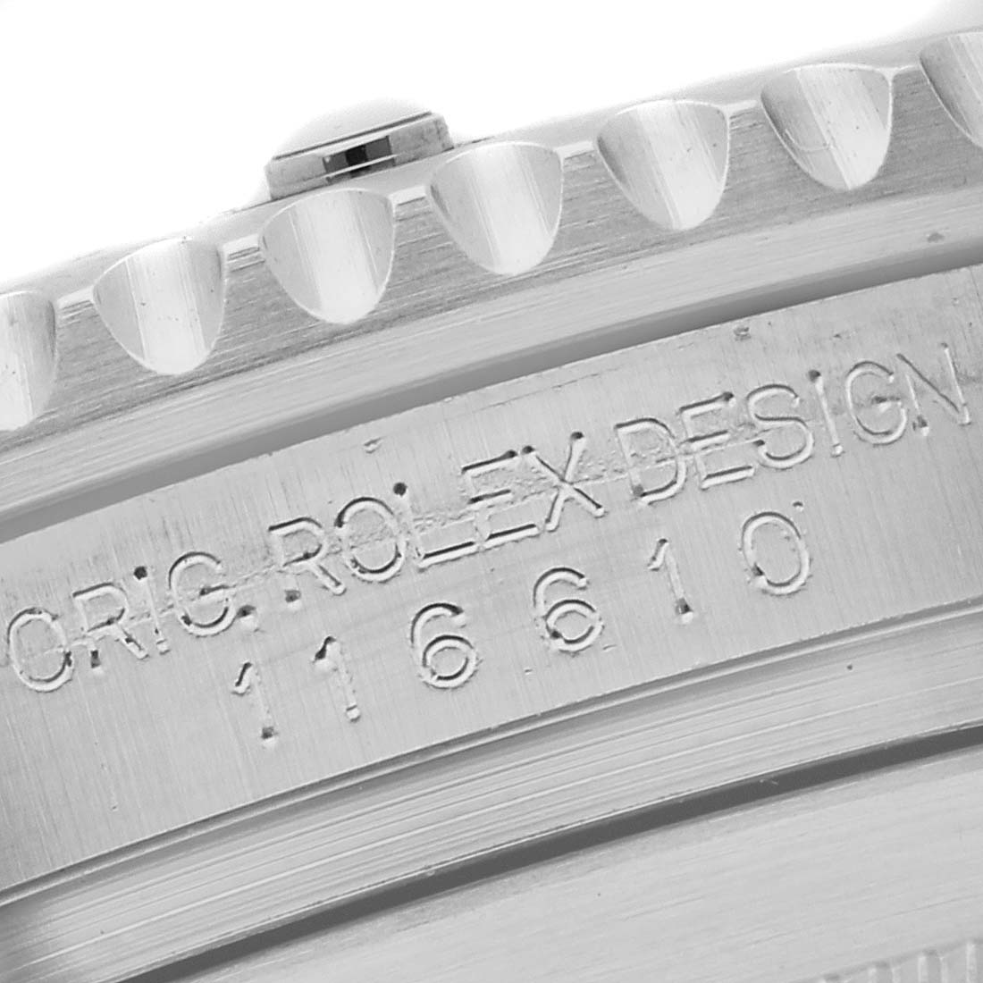 The image shows a close-up of the side of a Rolex Submariner 116610LV Men's Stainless Steel Green Dial 116610LV Men's Stainless Steel Green Dial watch case with engraved text and part of the bezel.