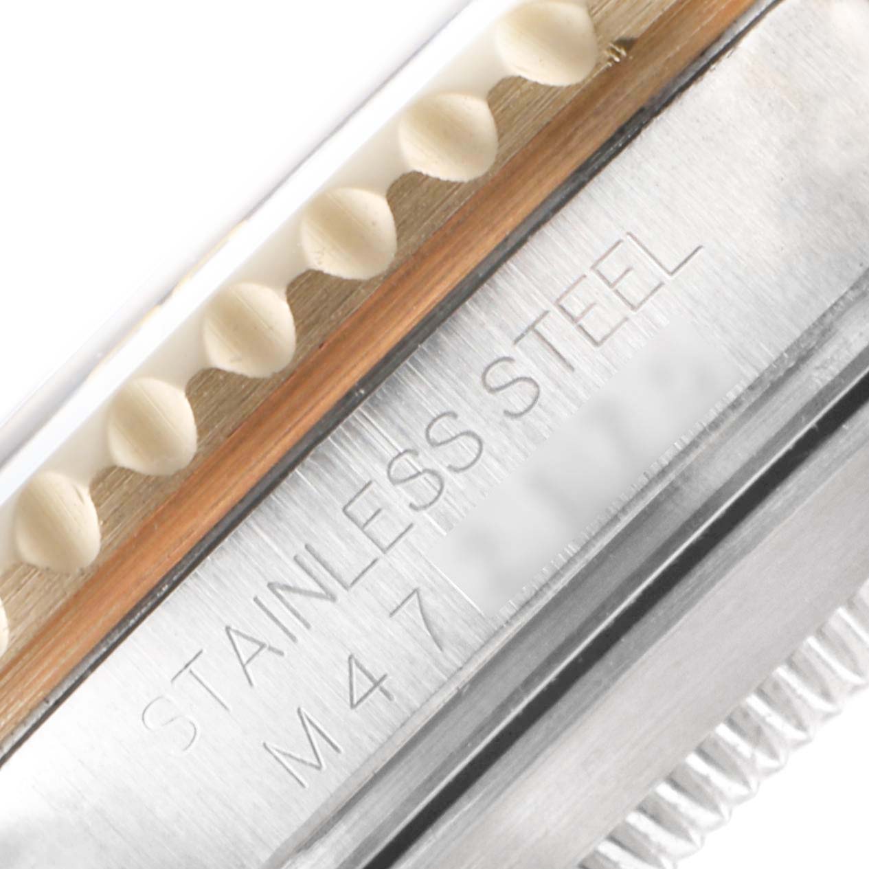 This close-up image shows the engraved "STAINLESS STEEL" marking on the side of the Rolex Submariner 16613 Men's Steel and Gold (two tone) Black Dial 16613 Men's Steel and Gold (two tone) Black Dial watch case.