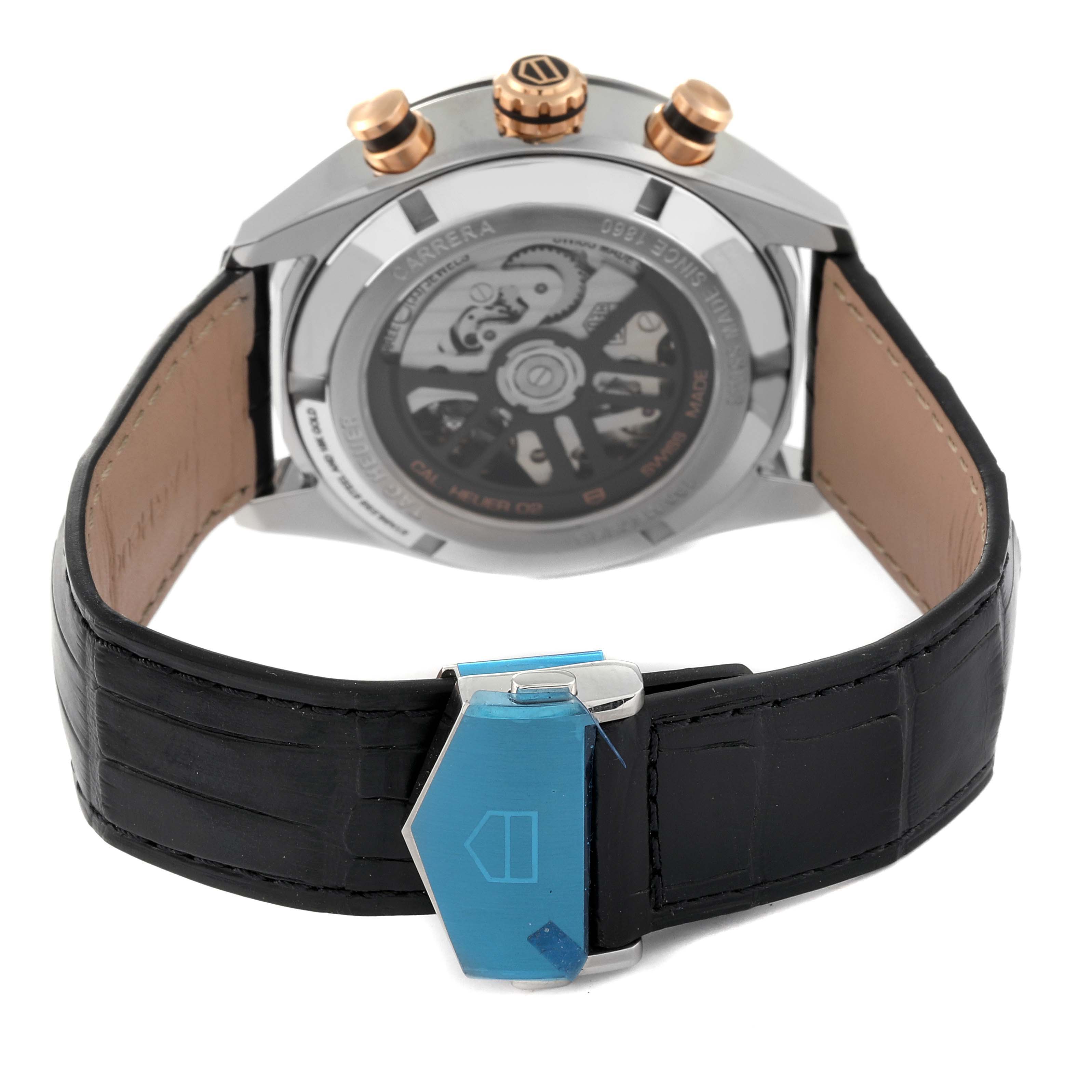 This image shows the back view of a Tag Heuer Carrera CBN2A5A.FC6481 Men's Steel and Gold (two tone) Black Dial CBN2A5A.FC6481 Men's Steel and Gold (two tone) Black Dial watch, displaying the movement through a transparent case back and a partially blue-clipped clasp.