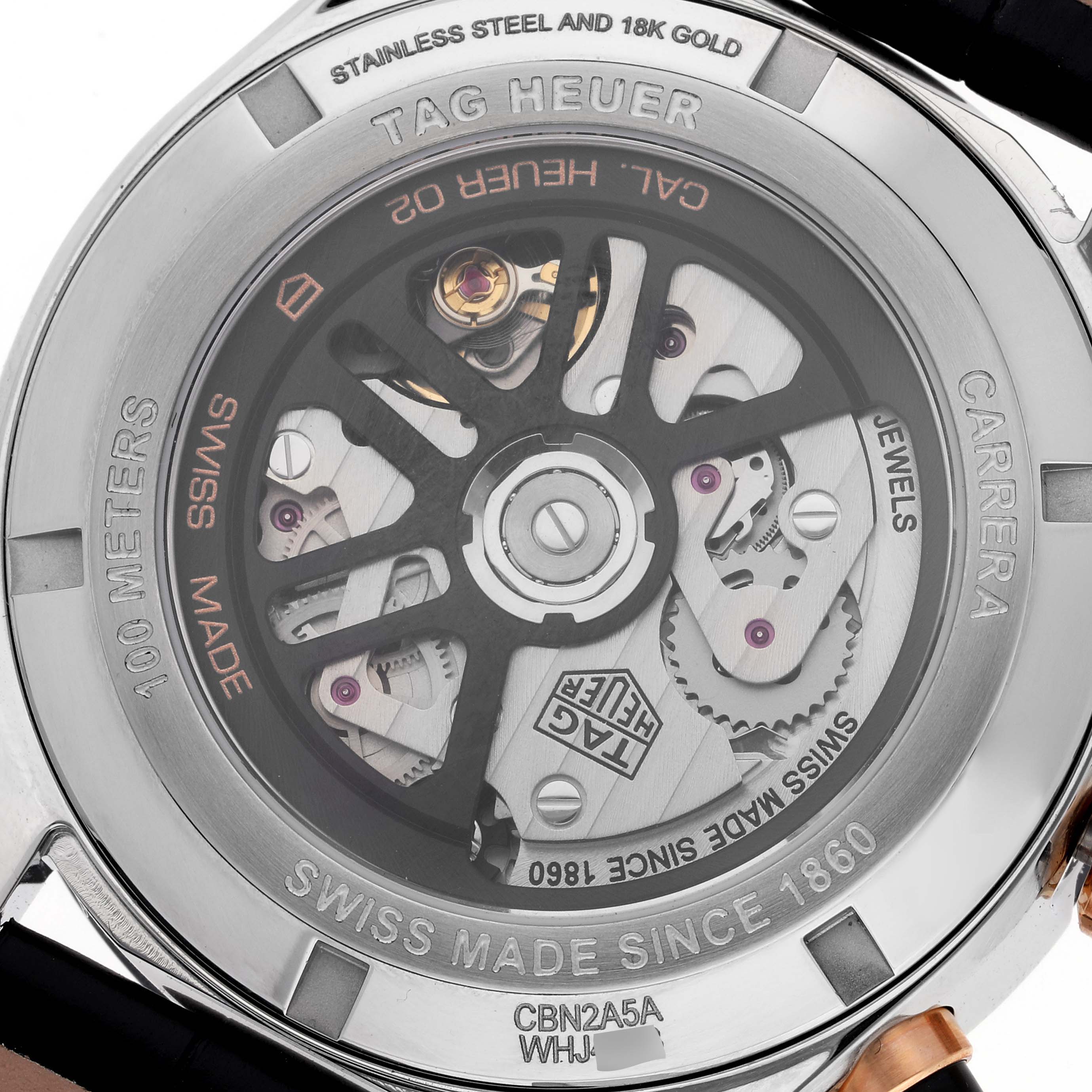 The image shows the back casing of a Tag Heuer Carrera CBN2A5A.FC6481 Men's Steel and Gold (two tone) Black Dial CBN2A5A.FC6481 Men's Steel and Gold (two tone) Black Dial watch, revealing the inner mechanical components and inscriptions.