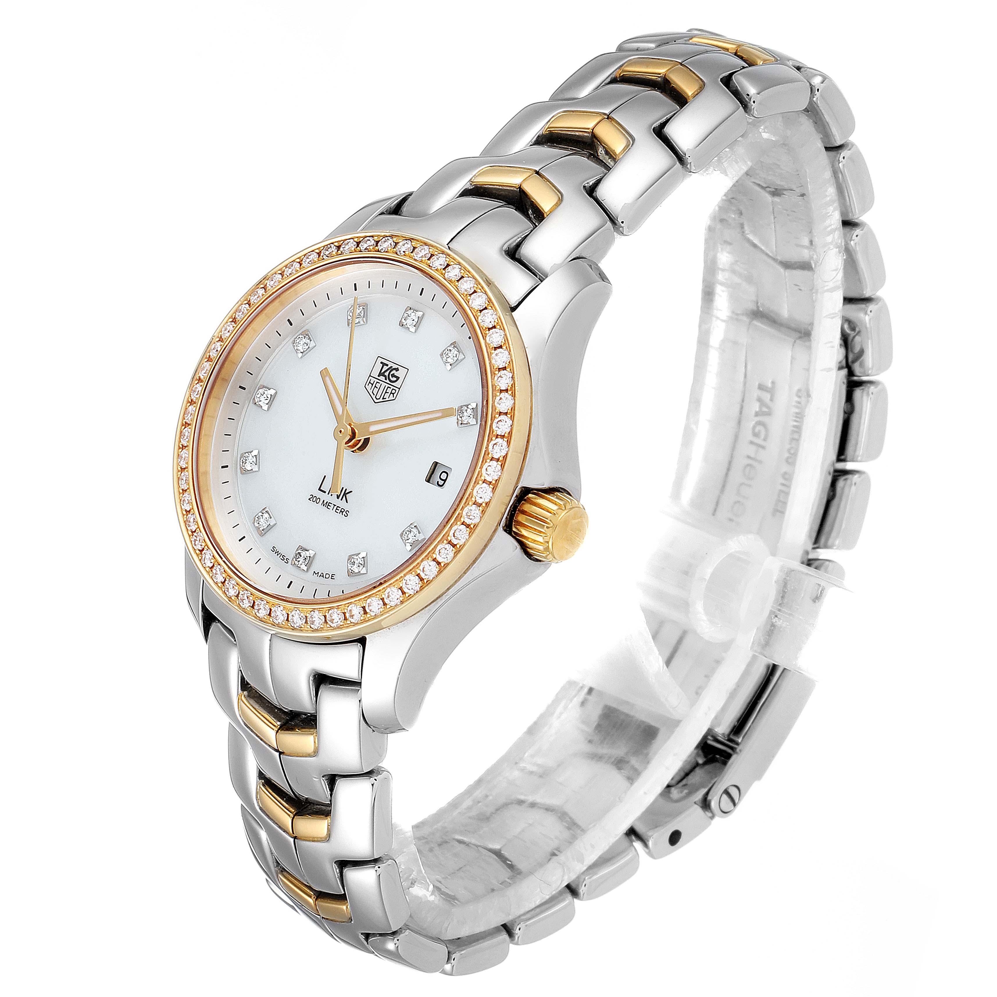 The image shows a Link model watch by Tag Heuer, showcasing its face, bezel, and bracelet at a three-quarter angle.