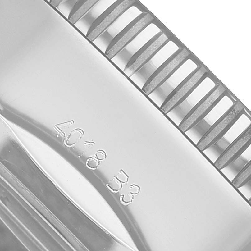 The image shows a close-up of the ridged edge and engraving on the bezel of the Breitling Superocean AB2030 Men's Stainless Steel Black Dial watch.