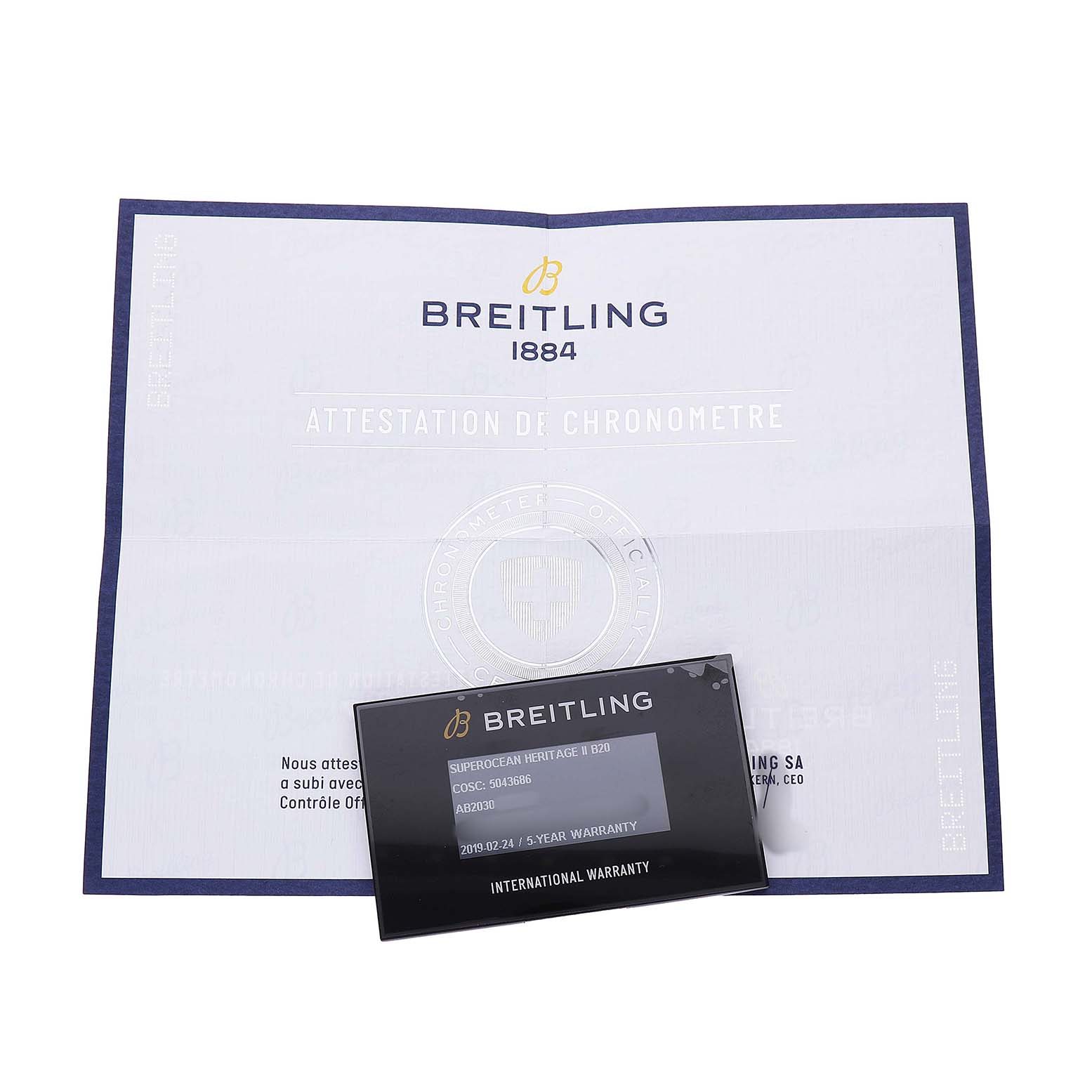 The image shows Breitling Superocean AB2030 Men's Stainless Steel Black Dial documentation, including a warranty card and chronometer certificate laid flat.