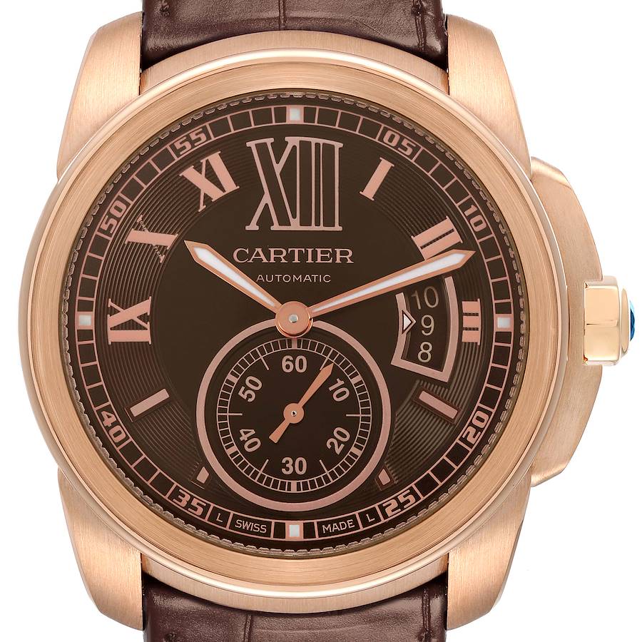 The Calibre de Cartier watch is shown from a front angle, displaying the dial, Roman numerals, subdial, and date window.