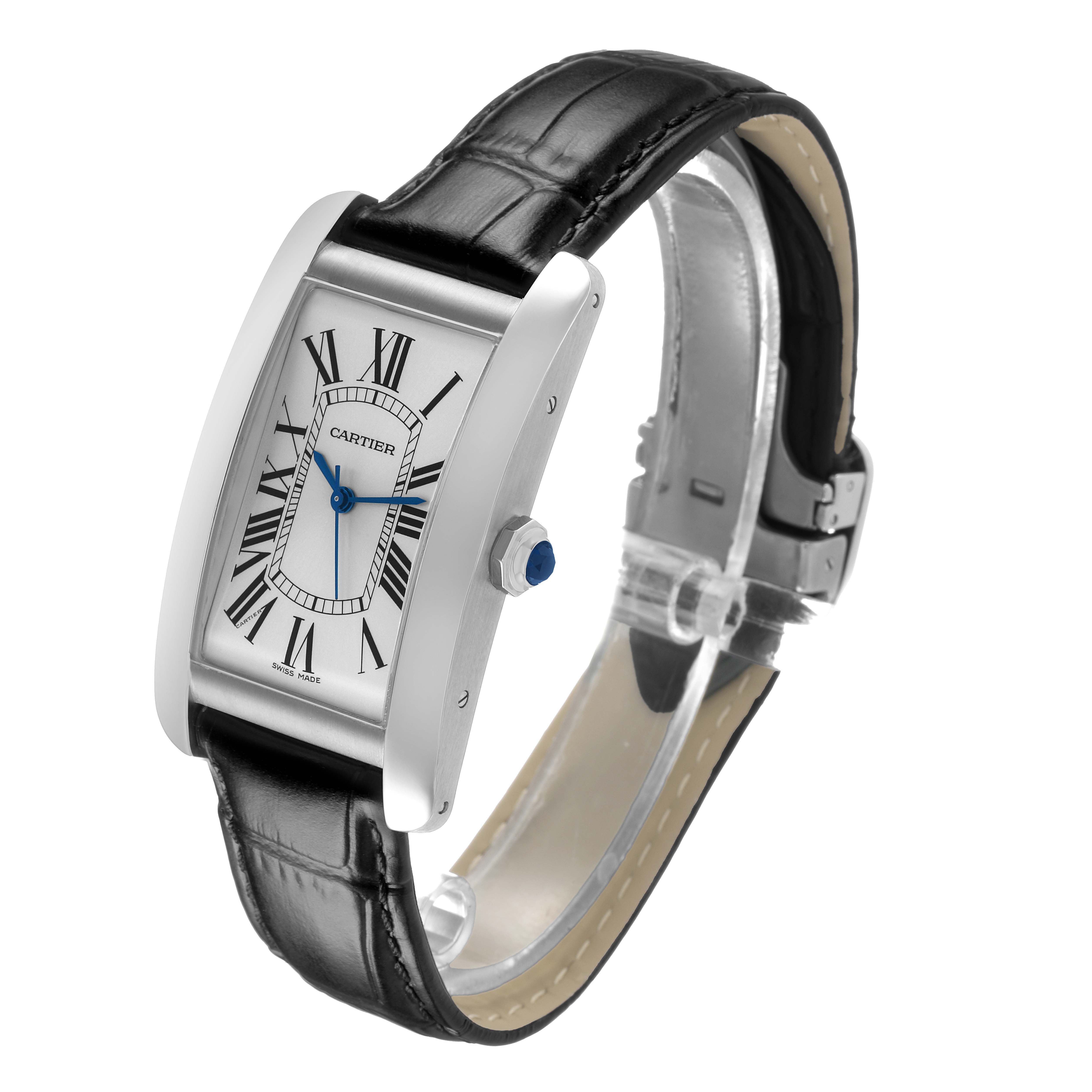 The Cartier Tank Américaine watch is shown at a three-quarter angle, highlighting the face, strap, and crown with a blue cabochon.