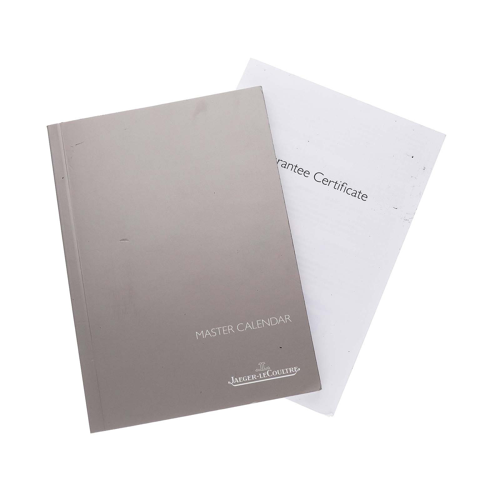 The image shows a Jaeger LeCoultre Master Q1558421 / 176.8.12.S Men's Stainless Steel Silver Dial Calendar booklet and a guarantee certificate, viewed from above.