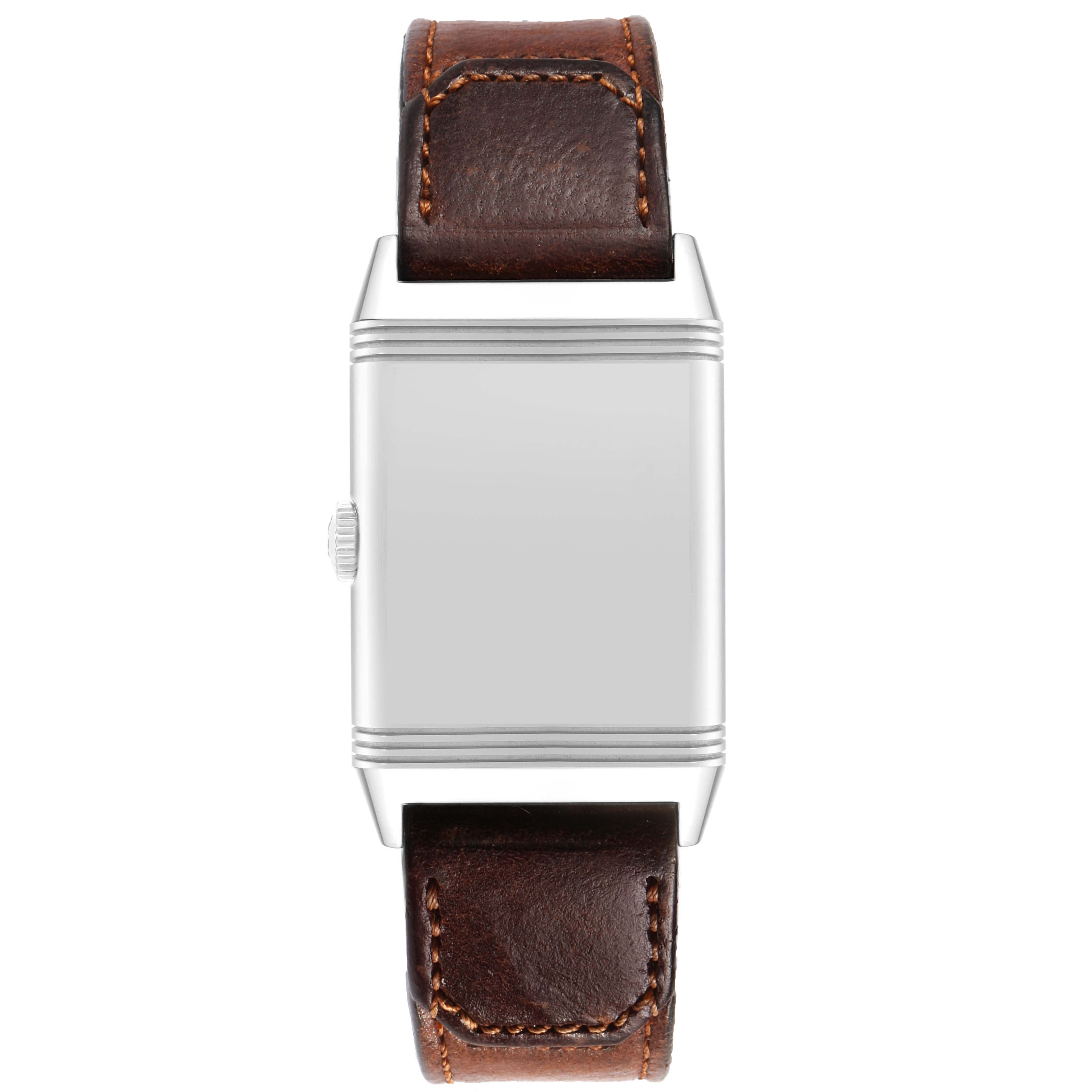 The Jaeger-LeCoultre Reverso watch is shown from the front, displaying its case, crown, and leather strap.