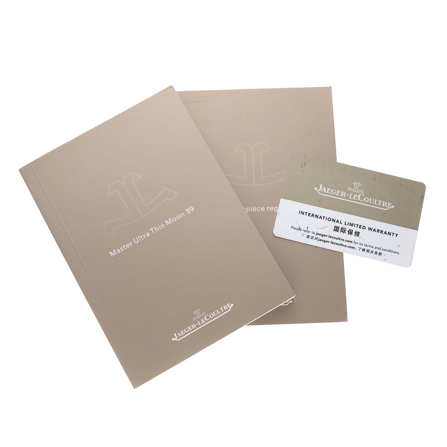 The image shows the Jaeger-LeCoultre Reverso model's manuals and an international limited warranty card.