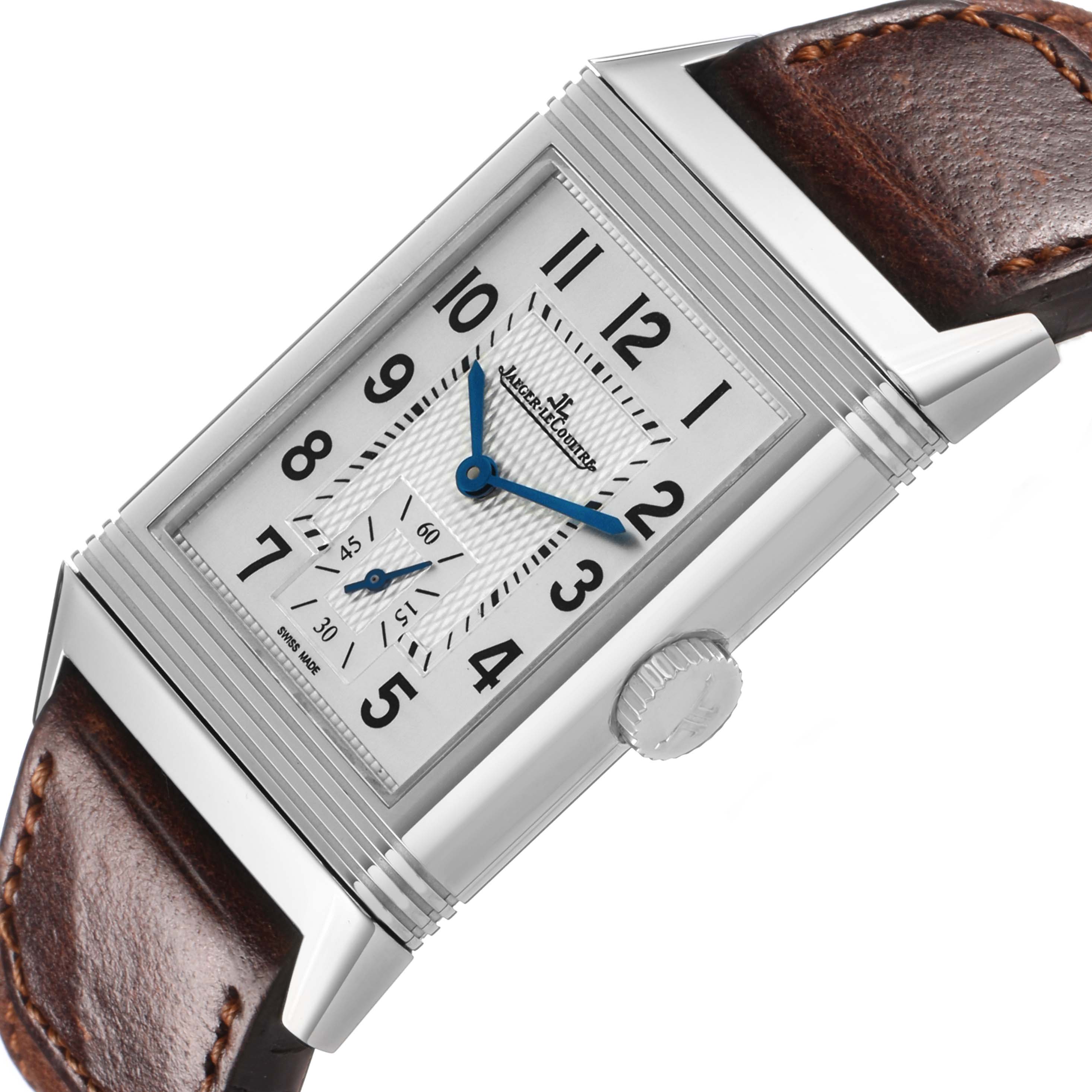 The Jaeger-LeCoultre Reverso watch is shown at an angle highlighting the front face, crown, and leather strap.
