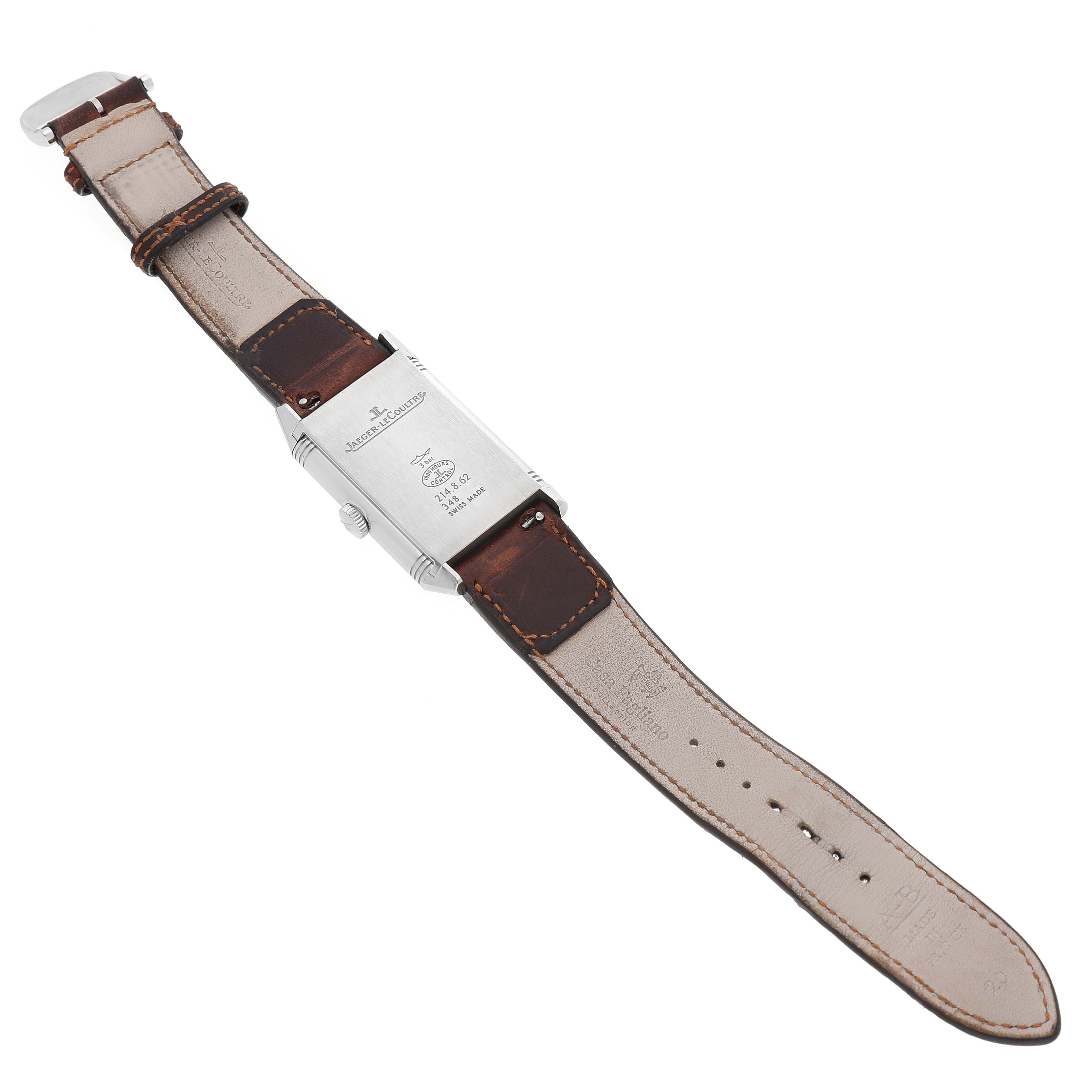 The Jaeger-LeCoultre Reverso watch is shown from the back, displaying the case and brown leather strap laid flat.