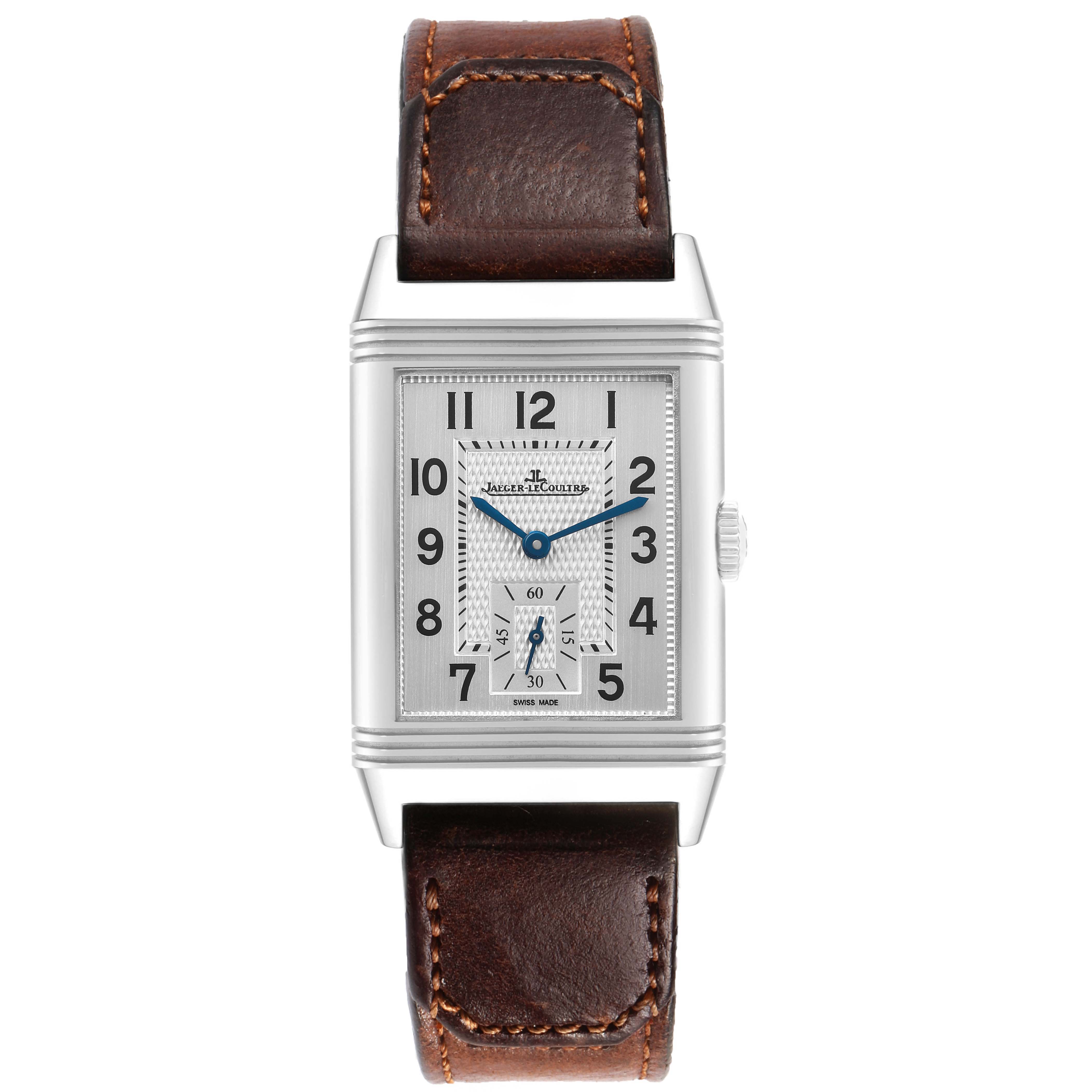 The Jaeger-LeCoultre Reverso watch is shown front-on, displaying its face, case, crown, and leather strap.