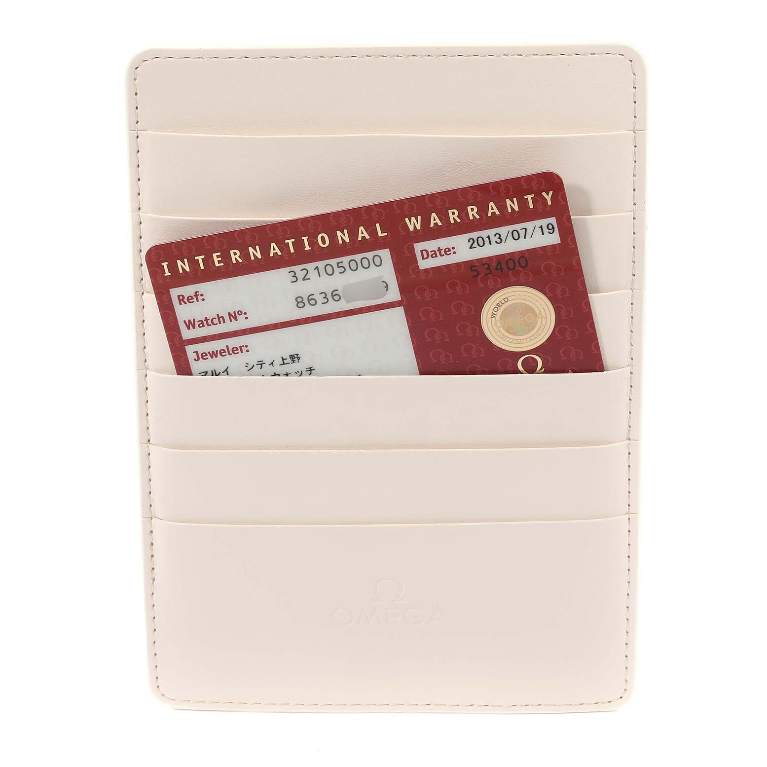 This image shows a front view of an Omega Speedmaster 3210.50.00 Men
s Stainless Steel Black Dial 3210.50.00 Men
s Stainless Steel Black Dial warranty card inside a beige cardholder.