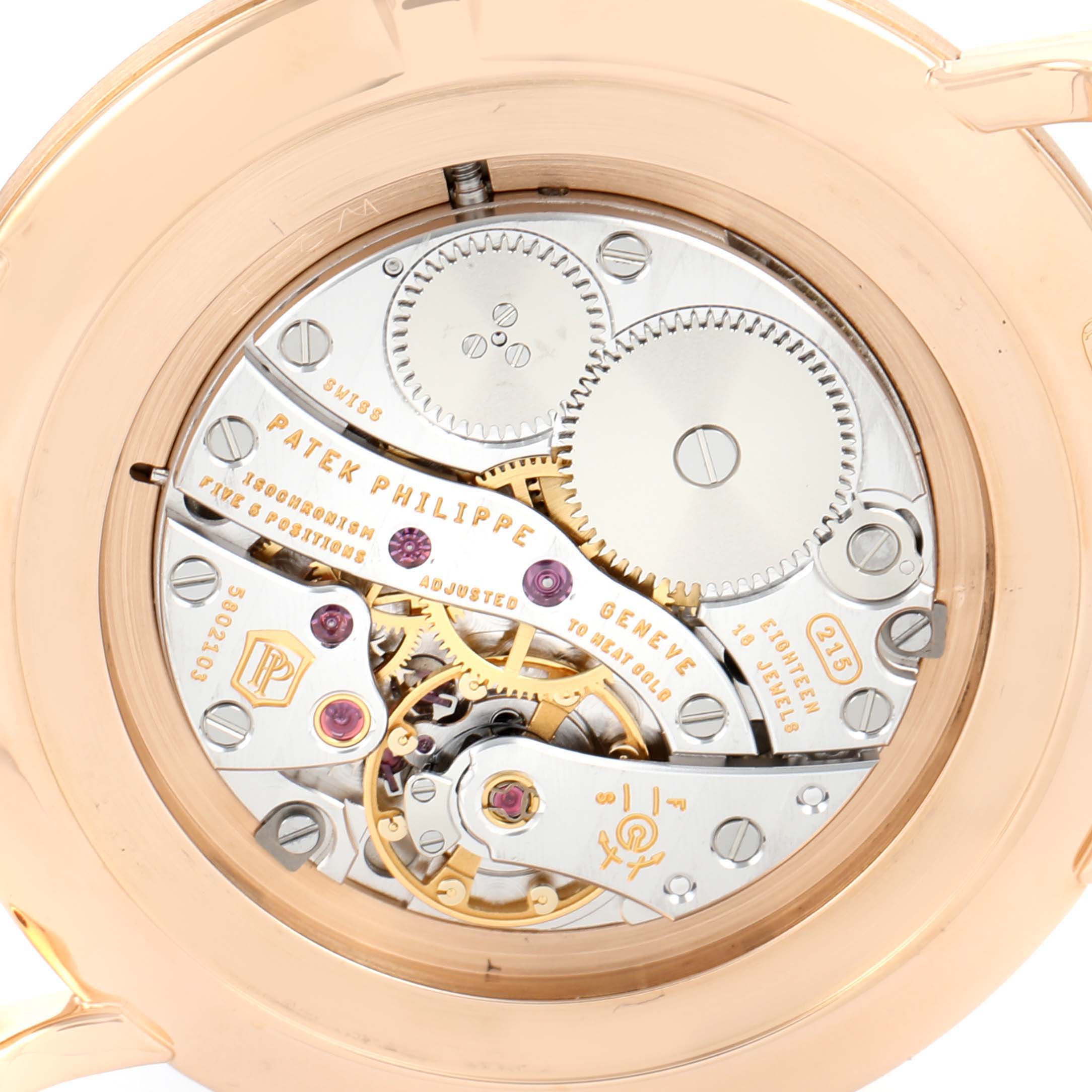 This image shows the intricate movement and inner workings of a Patek Philippe Calatrava 5119R Men
s Rose Gold White Dial 5119R Men
s Rose Gold White Dial watch from a back angle.