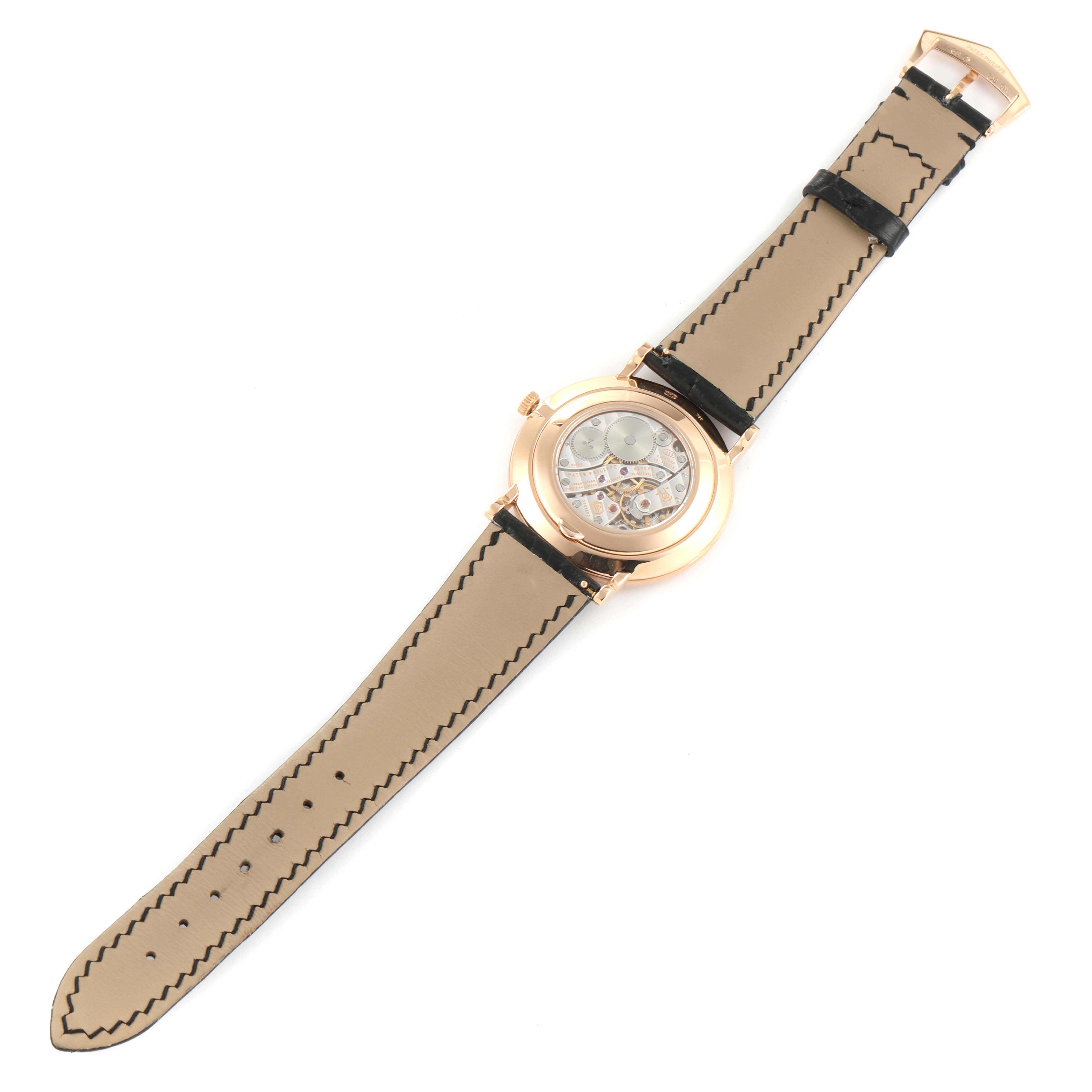 The image shows the back of a Patek Philippe Calatrava 5119R Men
s Rose Gold White Dial 5119R Men
s Rose Gold White Dial watch, highlighting the movement and the interior of the strap.