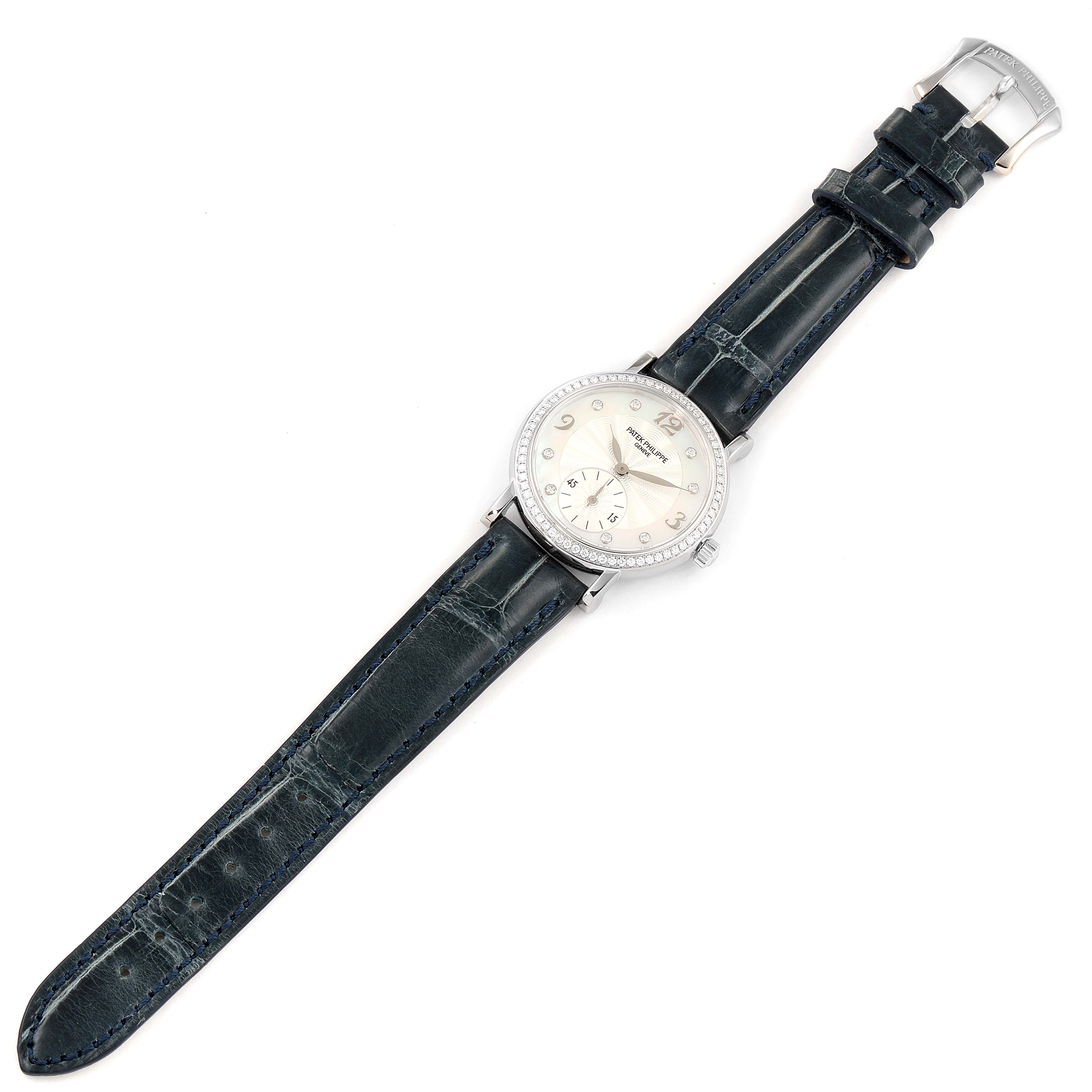 The image shows a top-down view of a Patek Philippe Calatrava 4959G Women's White Gold Mother of Pearl Dial 4959G Women's White Gold Mother of Pearl Dial watch, displaying its face, strap, and buckle.