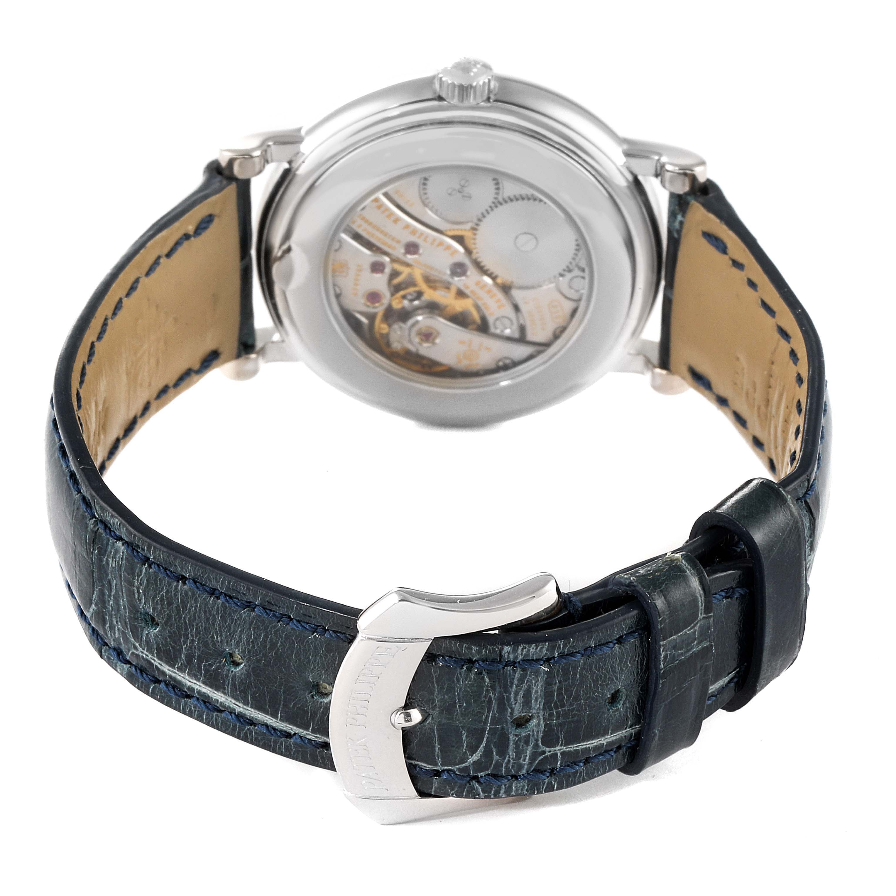 The image shows the back angle of the Patek Philippe Calatrava 4959G Women's White Gold Mother of Pearl Dial 4959G Women's White Gold Mother of Pearl Dial watch, highlighting its mechanical movement and leather strap with buckle.