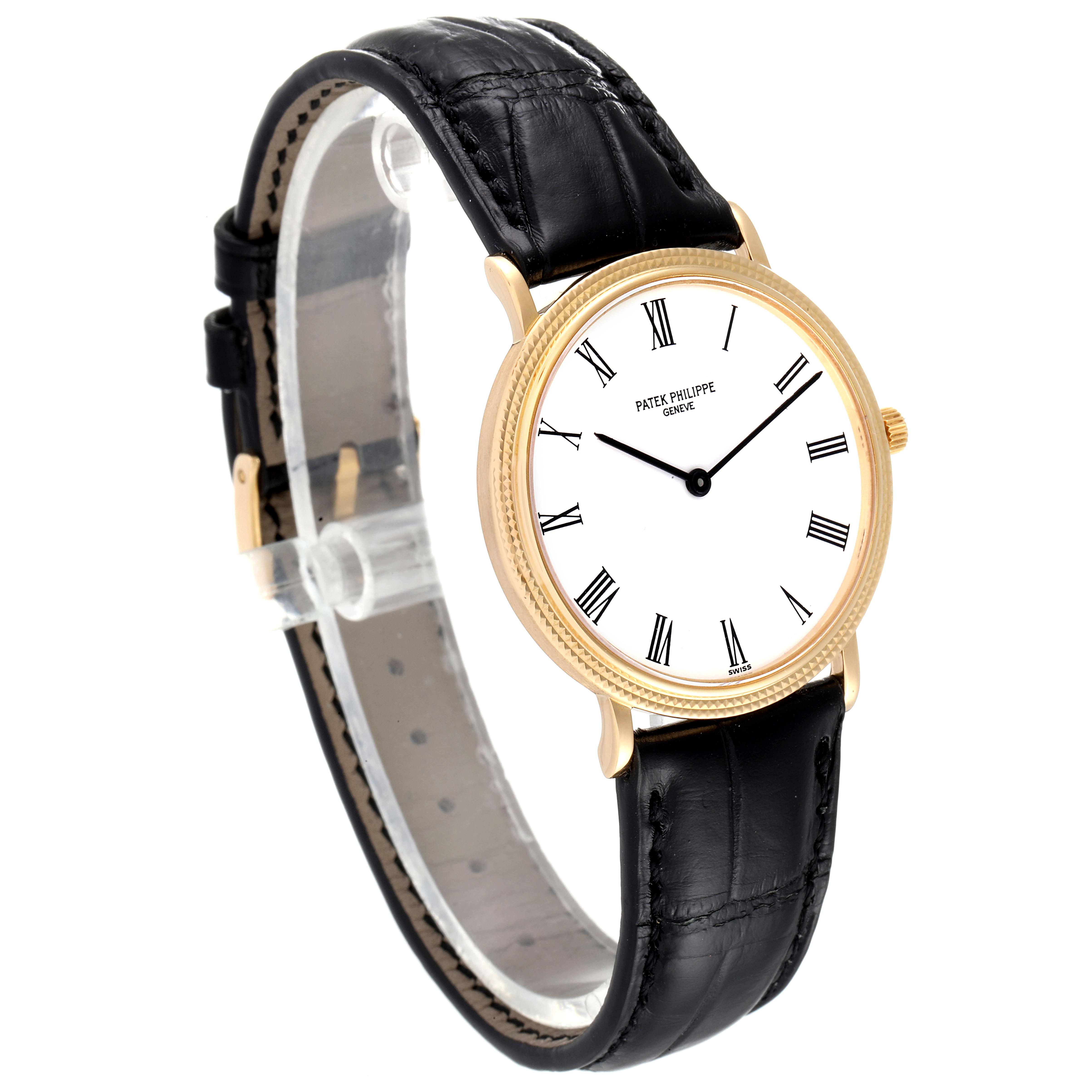 This image shows a Patek Philippe Calatrava 3954J Men's Yellow Gold White Dial 3954J Men's Yellow Gold White Dial watch at a 45-degree angle, highlighting its face, leather band, and buckle.