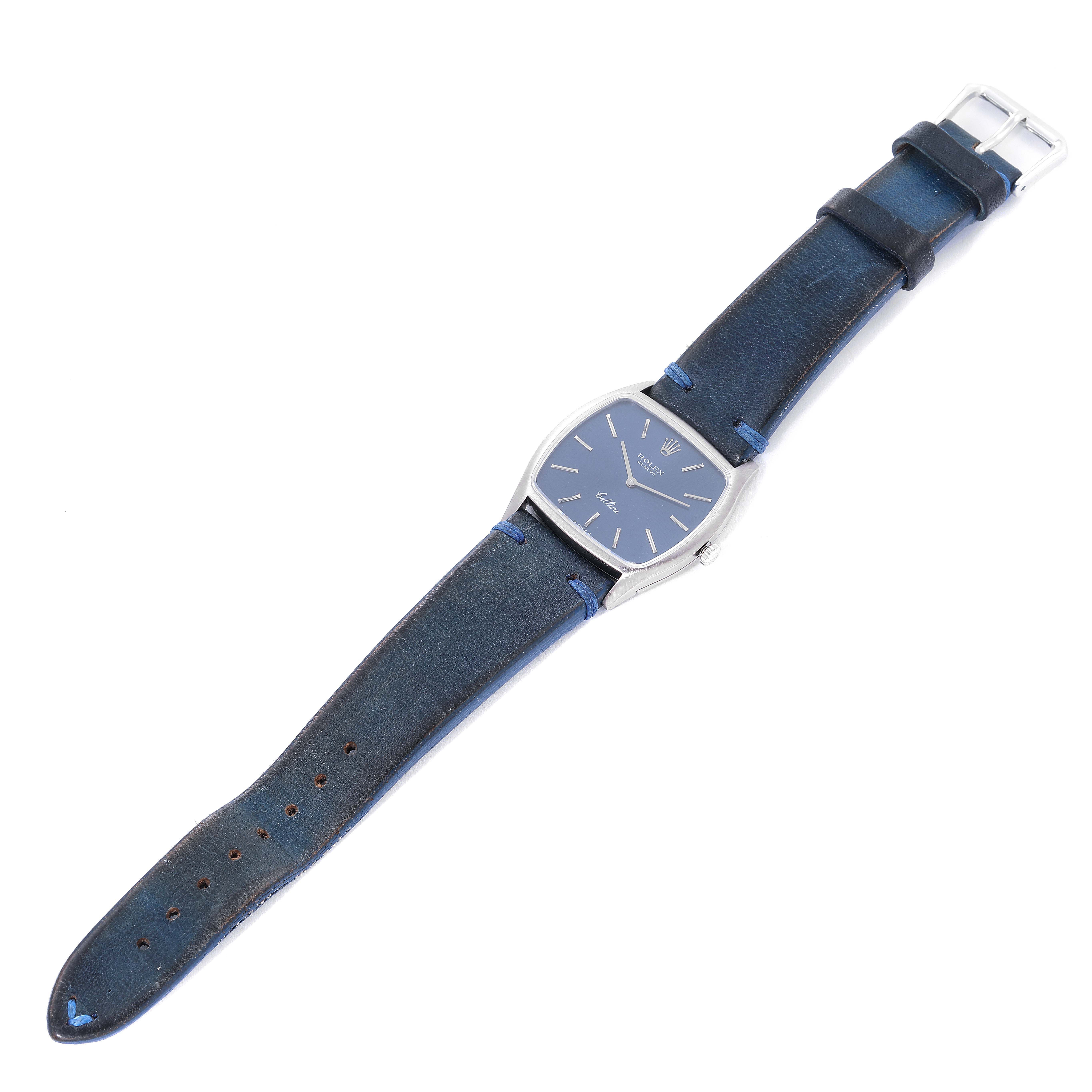 The image shows a top-down view of a Rolex Cellini 3805 Men's Stainless Steel Blue Dial 3805 Men's Stainless Steel Blue Dial watch, displaying its blue dial, silver case, and blue leather strap.