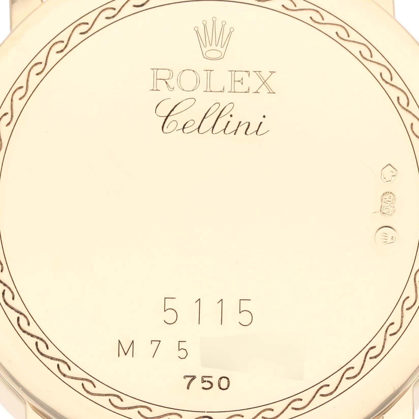 The image shows the back of a Rolex Cellini 5115 Men's Yellow Gold Champagne Dial 5115 Men's Yellow Gold Champagne Dial watch, highlighting engravings and the model number.