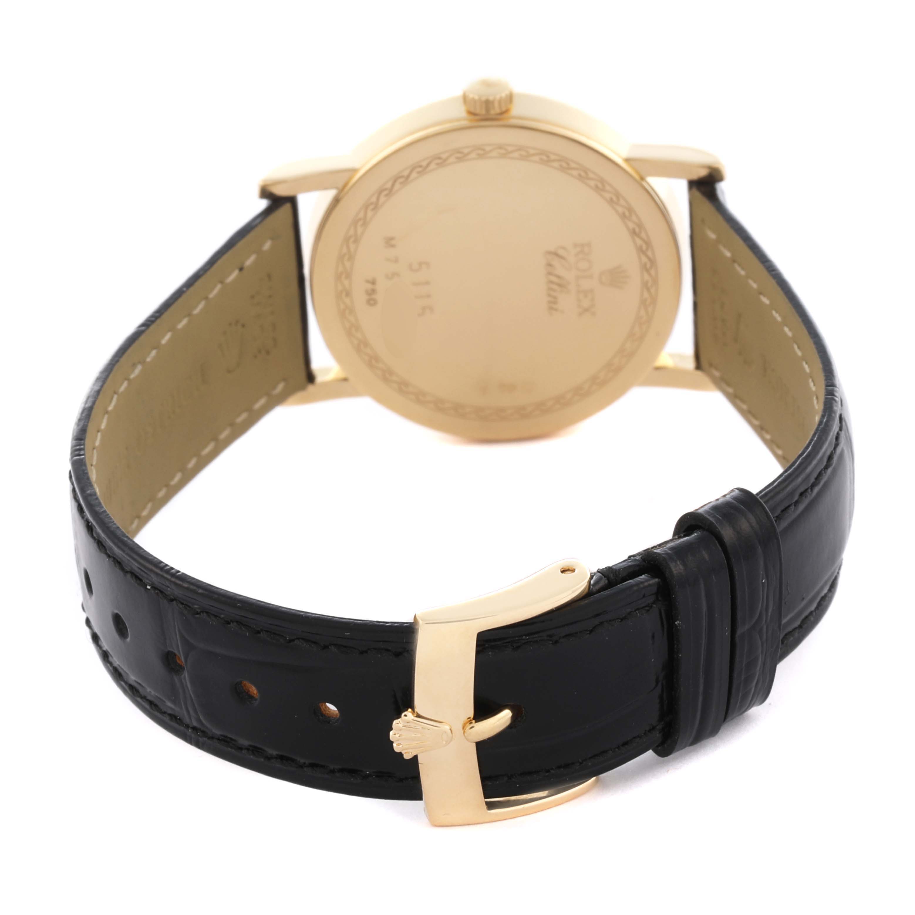 The Rolex Cellini 5115 Men's Yellow Gold Champagne Dial 5115 Men's Yellow Gold Champagne Dial watch is shown from the back, highlighting its gold case, leather strap, and buckle.