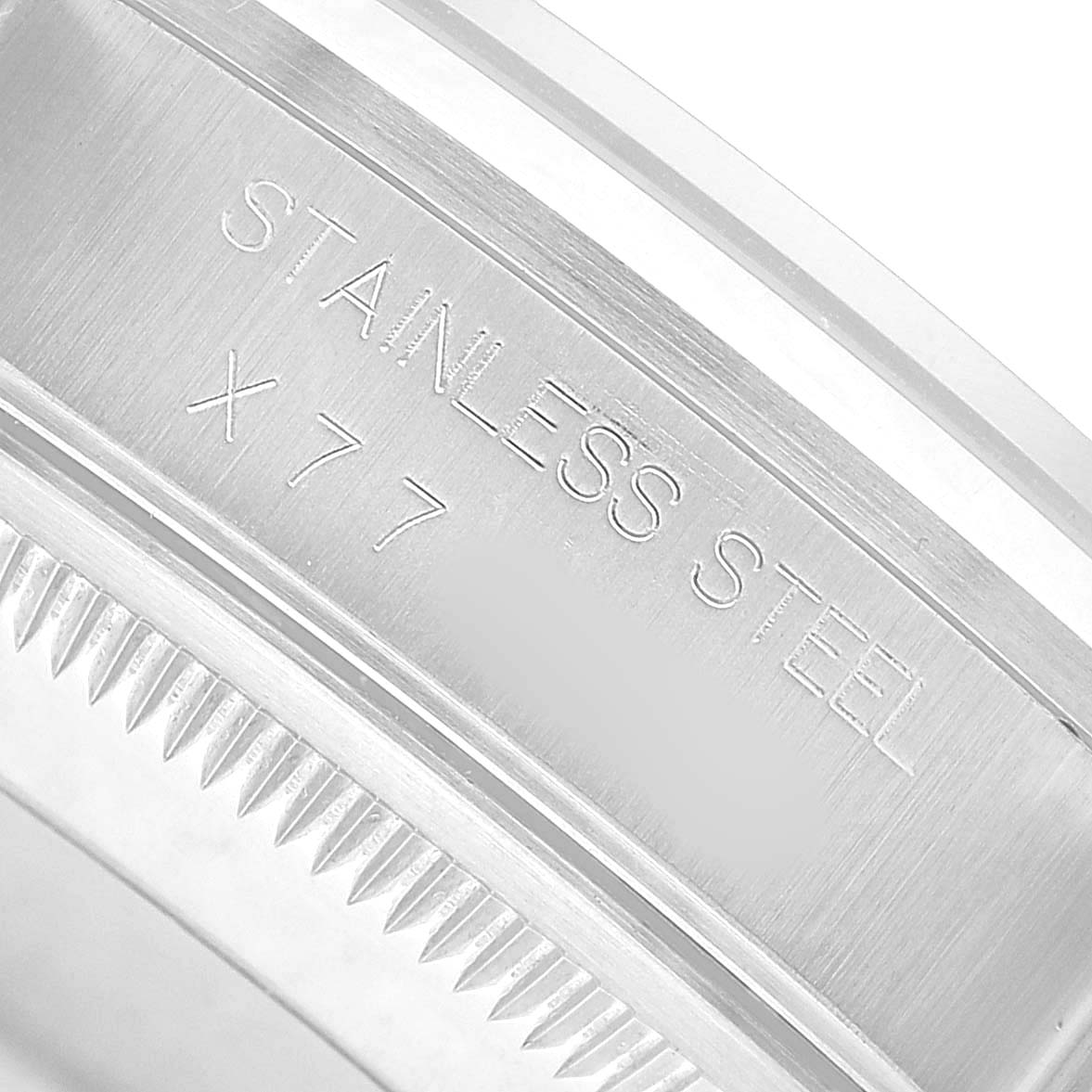 The image shows an angled close-up of the Rolex Date 15200 Men's Stainless Steel Blue Dial model bezel with "Stainless Steel" engraving.