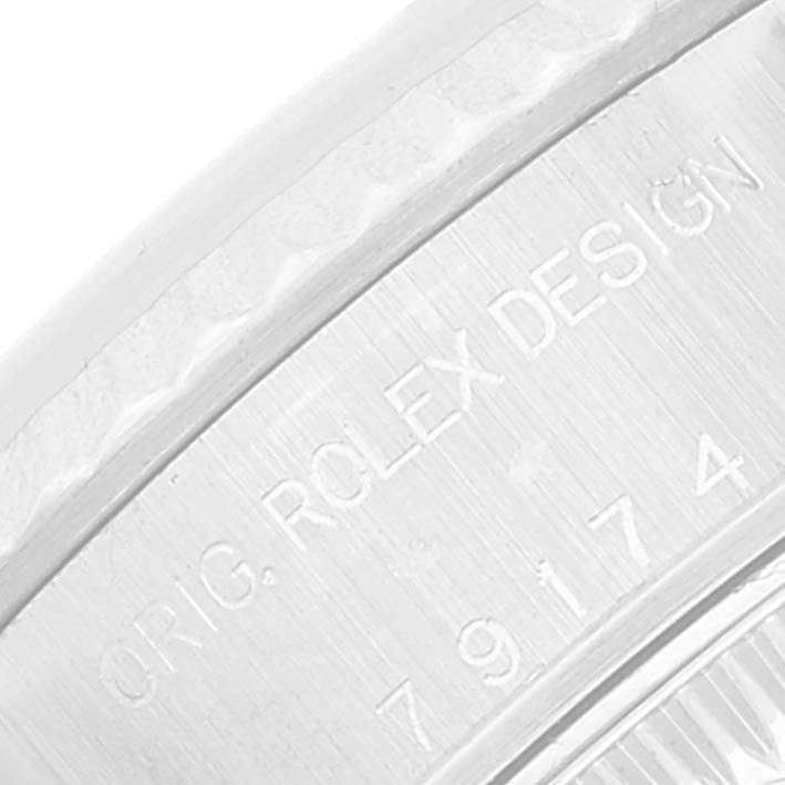 The image shows a close-up of the Rolex Datejust 79174 Women's Stainless Steel Silver Dial 79174 Women's Stainless Steel Silver Dial model's case, highlighting the engraved "ORIG. ROLEX DESIGN" inscription.