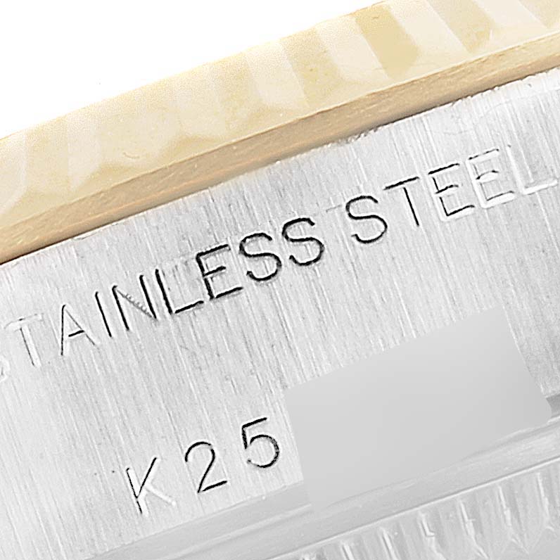 The image shows a close-up of the fluted bezel and stainless steel engraved side of a Rolex Datejust 79173 Women's Steel and Gold (two tone) Champagne Dial 79173 Women's Steel and Gold (two tone) Champagne Dial watch.