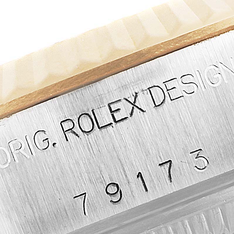 This image shows a close-up of the serial number and "ROLEX DESIGN" engraving on the case of a Rolex Datejust 79173 Women's Steel and Gold (two tone) Champagne Dial 79173 Women's Steel and Gold (two tone) Champagne Dial watch.
