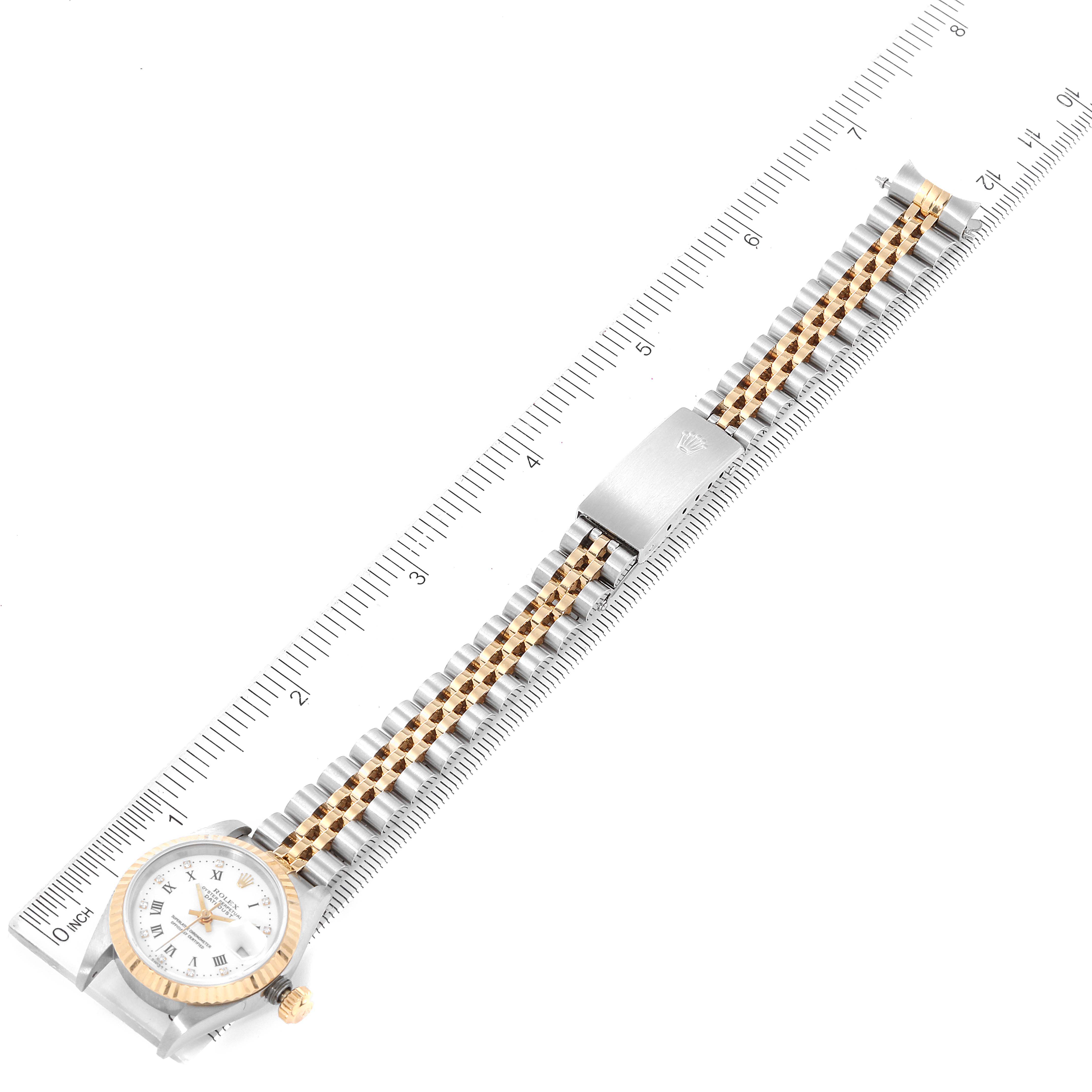 This image shows a top-down view of a Rolex Datejust 69173 Women's Steel and Gold (two tone) White Dial 69173 Women's Steel and Gold (two tone) White Dial watch, with the entire watch and its two-tone band laid flat beside a ruler.