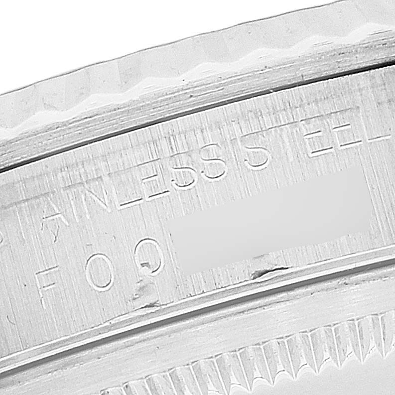 The image shows a close-up of the engraved stainless steel caseback edge to bezel of a Rolex Datejust 16234 Men's Stainless Steel Silver Dial 16234 Men's Stainless Steel Silver Dial watch.