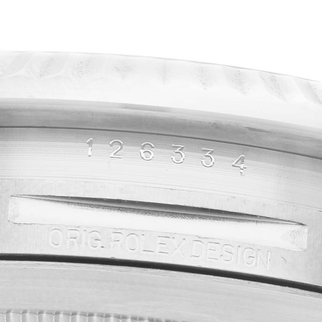 The image shows a close-up of the Datejust 41 model by Rolex, highlighting engraved serial and design numbers.