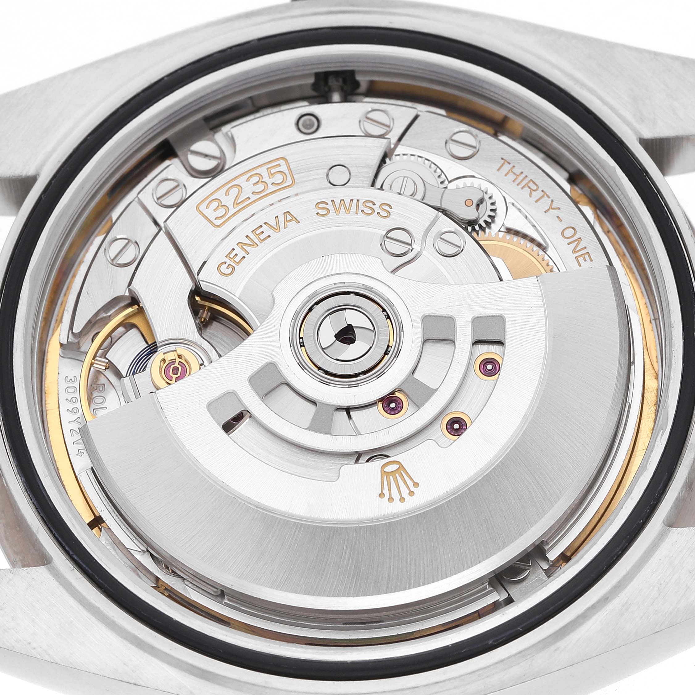 The image shows the movement mechanism of a Rolex Datejust 41 126334 Men's Stainless Steel Mother of Pearl Dial, viewed from the back with visible gears and inscriptions.