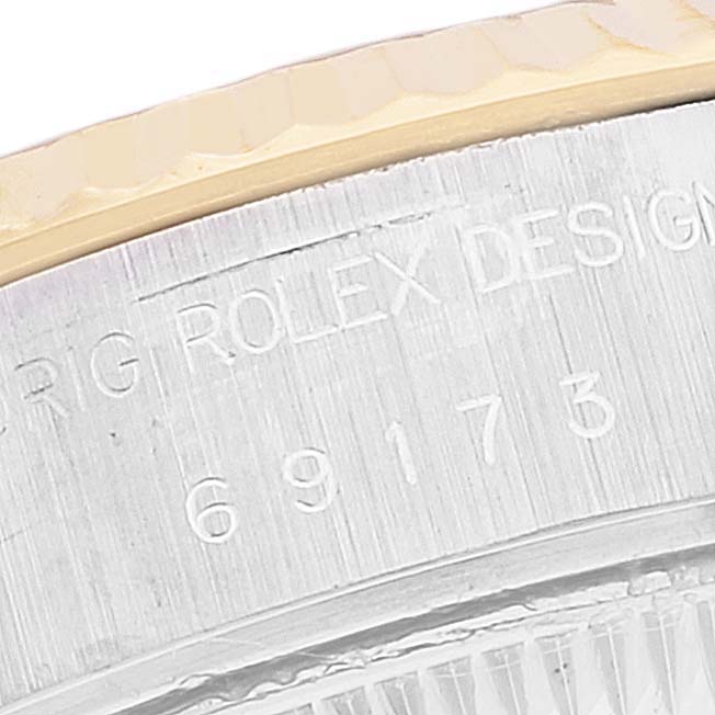 Close-up of the side view of a Rolex Datejust 69173 Women's Steel and Gold (two tone) Champagne Dial 69173 Women's Steel and Gold (two tone) Champagne Dial watch, showing the serial number and part of the bezel.