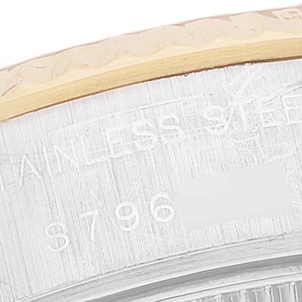 This image shows a close-up of the case back edge of a Rolex Datejust 69173 Women's Steel and Gold (two tone) Champagne Dial 69173 Women's Steel and Gold (two tone) Champagne Dial watch, revealing the serial number and part of the stainless steel marking.