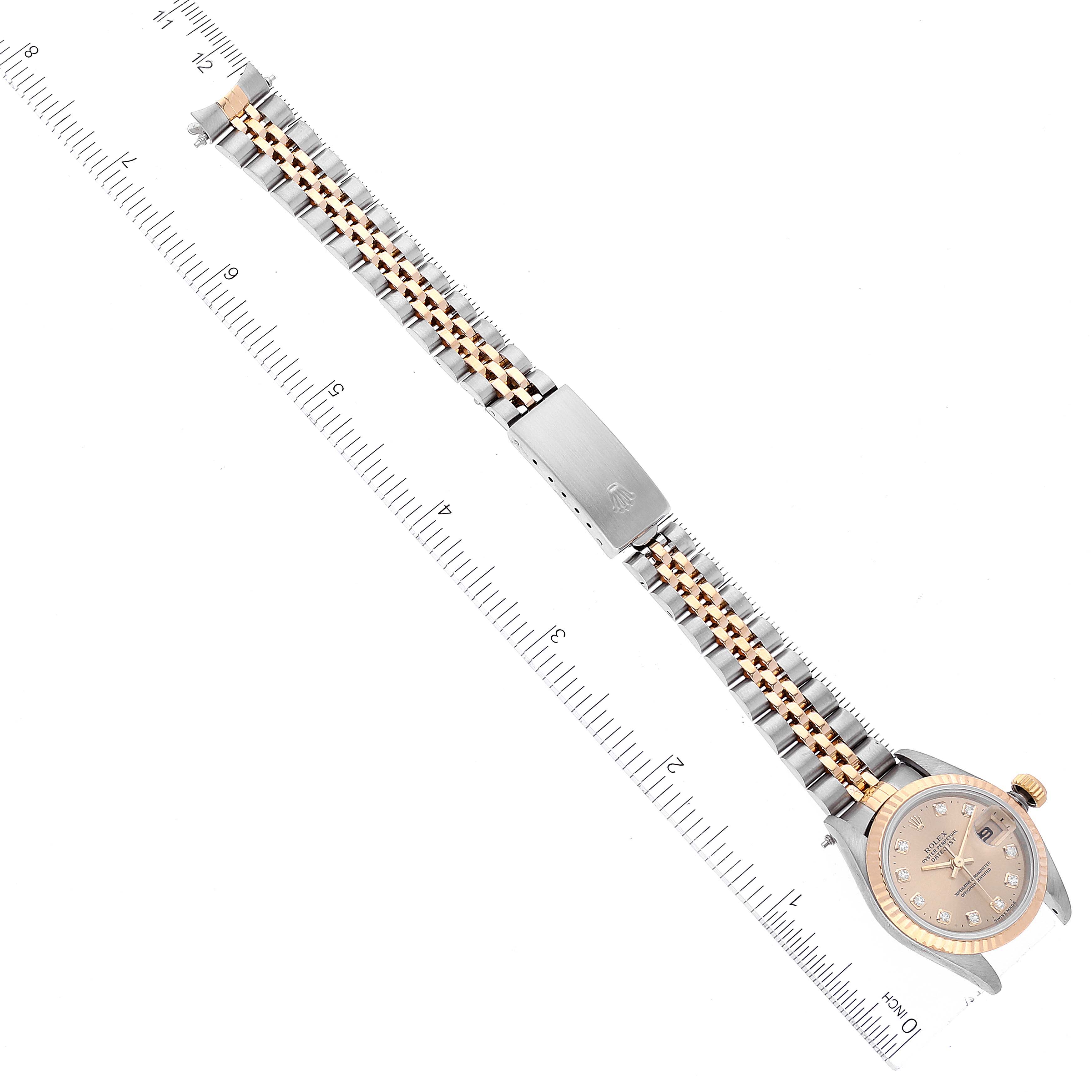 The image shows a top view of a Rolex Datejust 69173 Women's Steel and Gold (two tone) Champagne Dial 69173 Women's Steel and Gold (two tone) Champagne Dial watch with a two-tone bracelet alongside a ruler for scale.