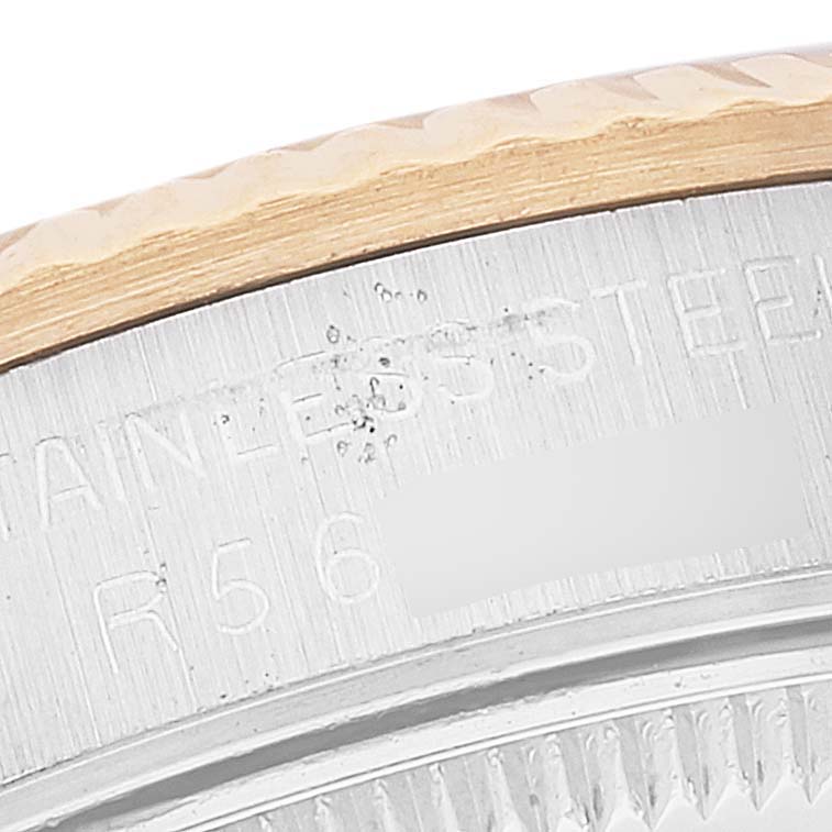 This close-up image shows the side engraving and part of the bezel of a Rolex Mid-Size 68273 Women's Steel and Gold (two tone) White Dial 68273 Women's Steel and Gold (two tone) White Dial watch.