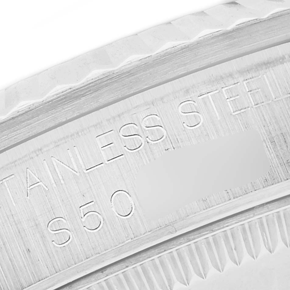 This close-up image shows the side engraving of a Mid-Size Rolex watch, highlighting the "stainless steel" and part of the serial number.