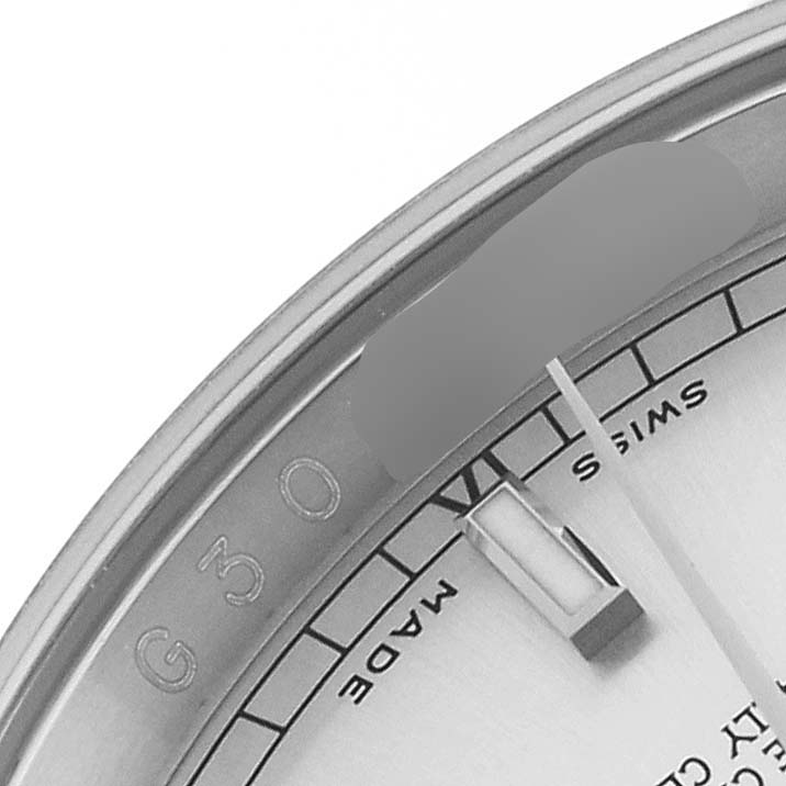 The image shows a close-up of a Rolex Datejust 116200 Men's Stainless Steel Silver Dial 116200 Men's Stainless Steel Silver Dial watch dial featuring the "Swiss Made" text and part of the bezel.