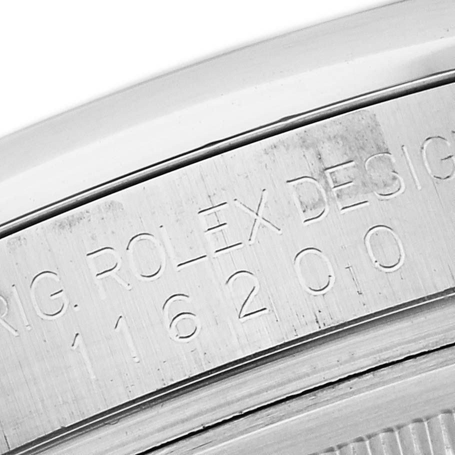 This close-up image shows the side casing of a Rolex Datejust 116200 Men's Stainless Steel Silver Dial 116200 Men's Stainless Steel Silver Dial watch with the model number engraved.