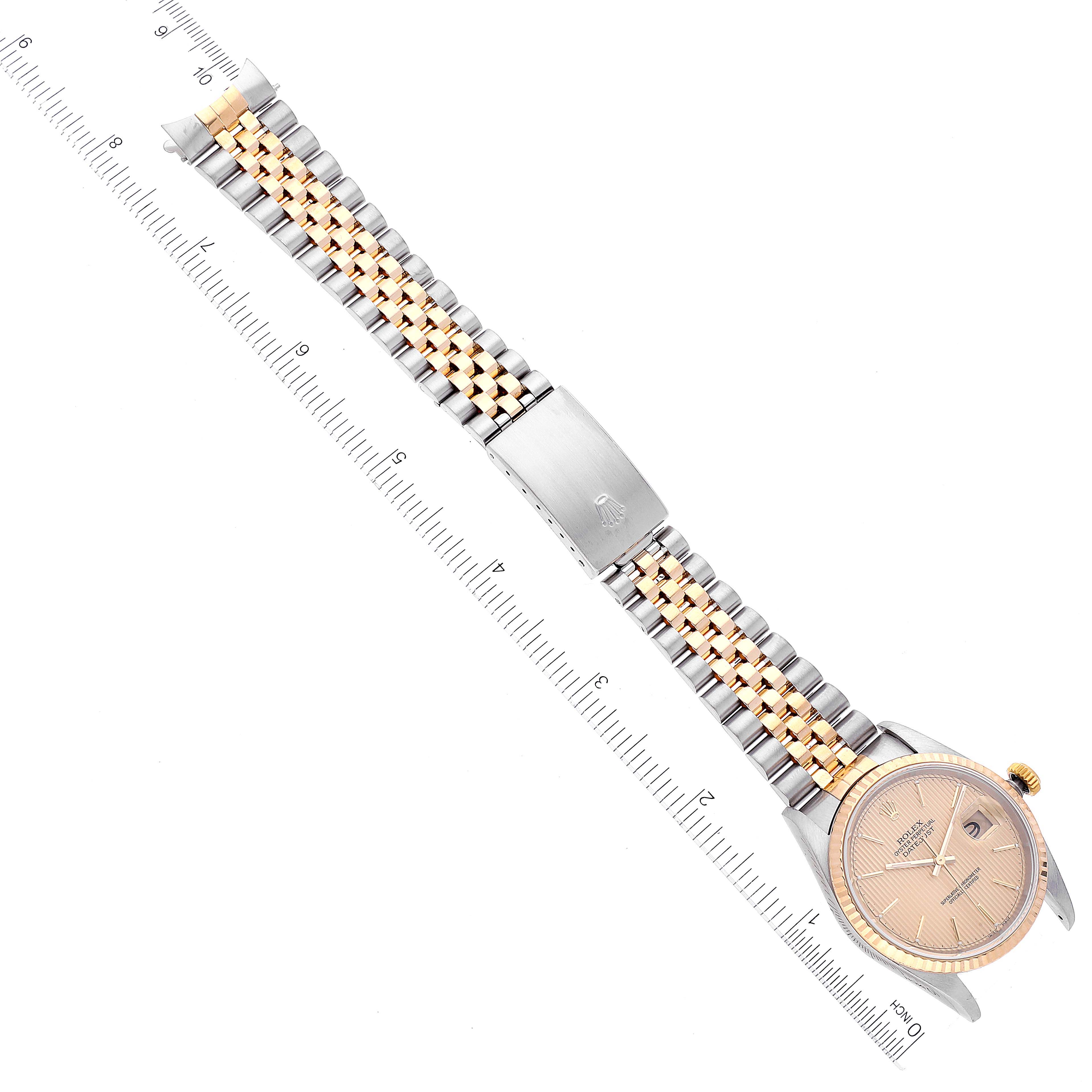 The image shows a Rolex Datejust 16233 Men's Steel and Gold (two tone) Champagne Dial 16233 Men's Steel and Gold (two tone) Champagne Dial watch laid flat with a ruler alongside, displaying the entire band and face.