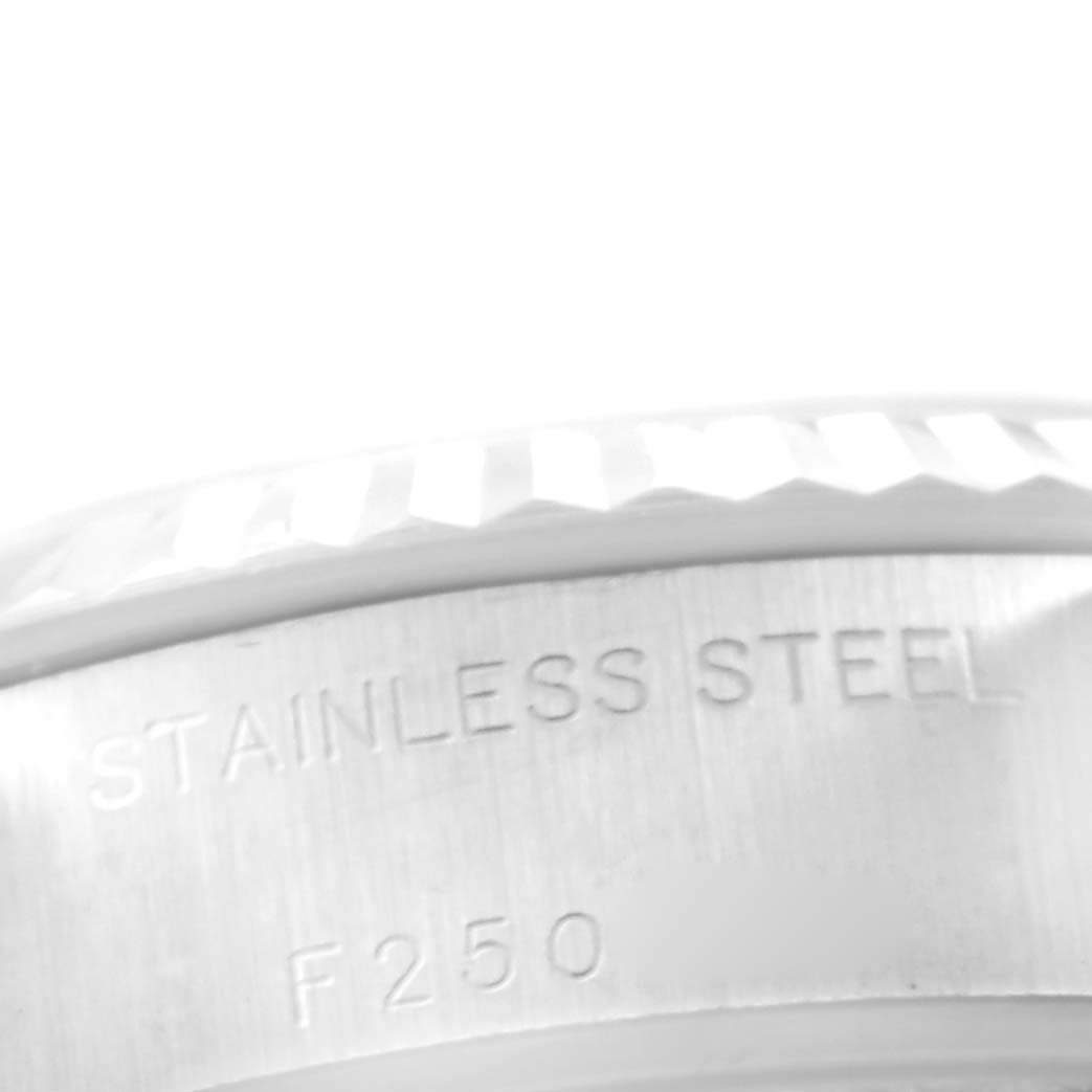 This close-up image shows the stainless steel case back with engravings and part of the fluted bezel of a Rolex Datejust 79174 Women
s Stainless Steel Mother of Pearl Dial 79174 Women
s Stainless Steel Mother of Pearl Dial watch.