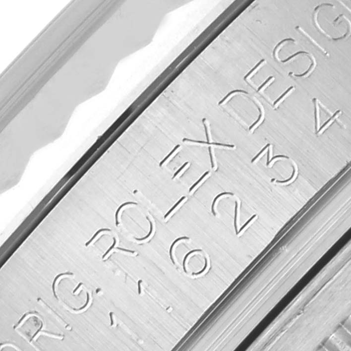 The image shows a close-up angle of the engraved side or bezel of a Rolex Datejust 116234 Men
s Stainless Steel Silver Dial 116234 Men
s Stainless Steel Silver Dial watch.