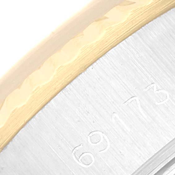 The image shows a close-up of a Rolex Datejust 69173 Women's Steel and Gold (two tone) Champagne Dial 69173 Women's Steel and Gold (two tone) Champagne Dial watch bezel and part of the case with engraving.