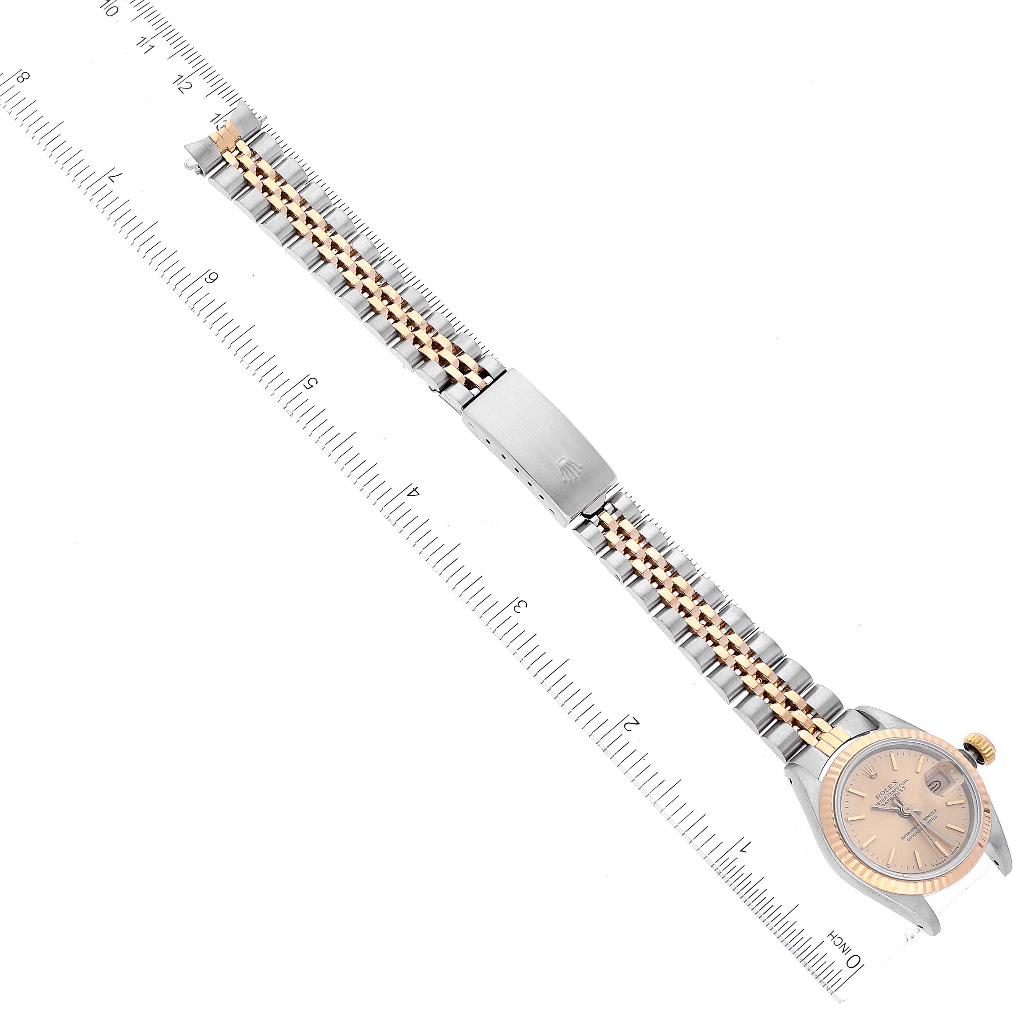 The image shows a top-down view of a Rolex Datejust 69173 Women's Steel and Gold (two tone) Champagne Dial 69173 Women's Steel and Gold (two tone) Champagne Dial watch, showcasing its dial, bracelet, and clasp with a ruler for scale.