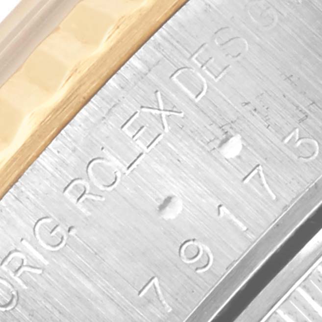 This close-up image shows the engraved edge of a Rolex Datejust 79173 Women's Steel and Gold (two tone) Champagne Dial 79173 Women's Steel and Gold (two tone) Champagne Dial watch case near the bezel.