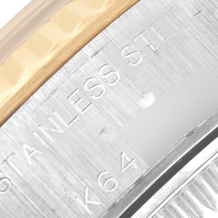 The image shows a close-up of the bezel and edge of the case back of a Rolex Datejust 79173 Women's Steel and Gold (two tone) Champagne Dial 79173 Women's Steel and Gold (two tone) Champagne Dial, highlighting "stainless steel" engraving.